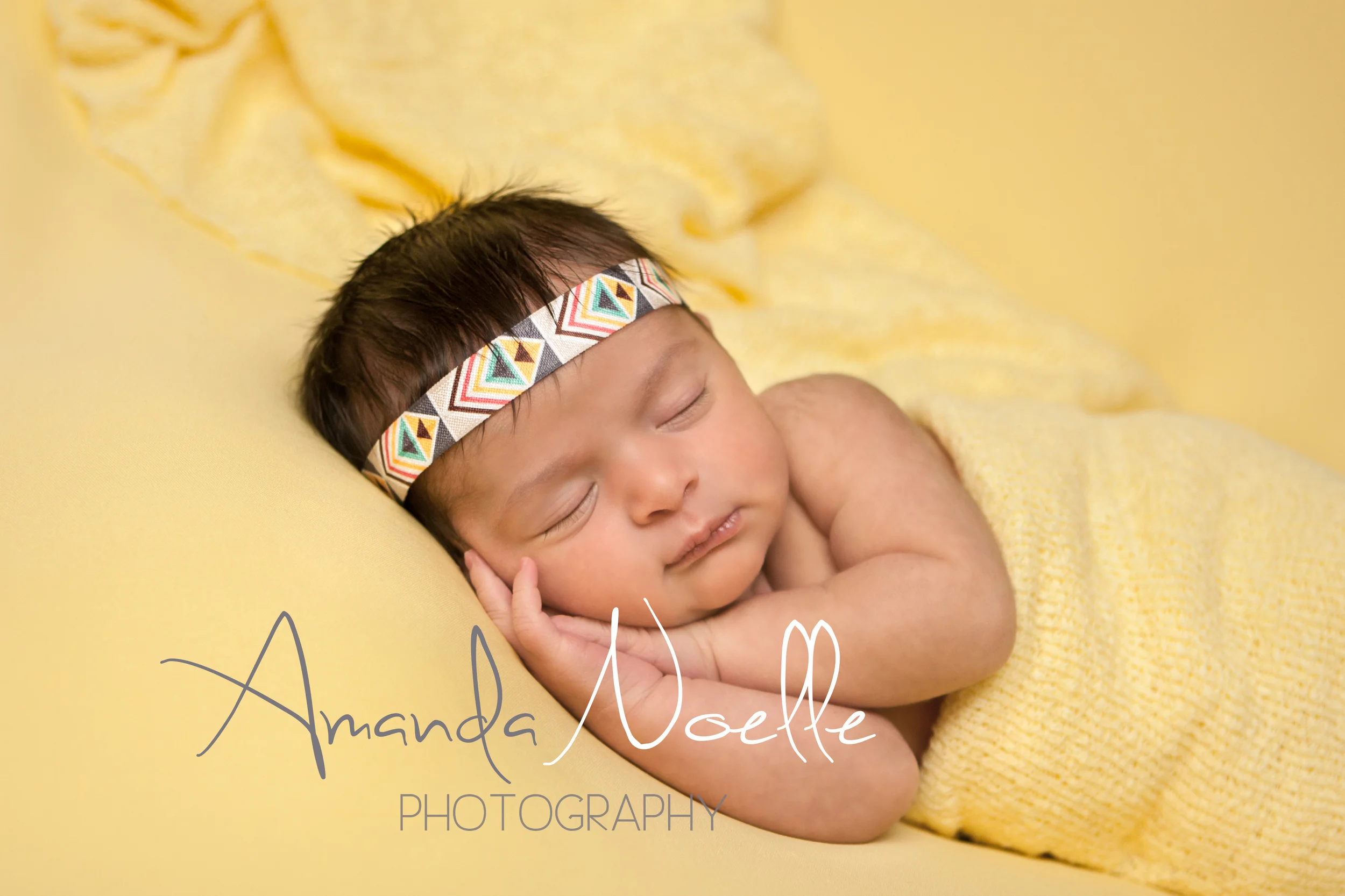 Newborn baby girl sleeping with bohemian aztec headband wrapped in yellow stretch knit wrap on yellow fabric backdrop, beanbag pose, Westchester, County New York Newborn Photographer, Amanda Noelle Photography.