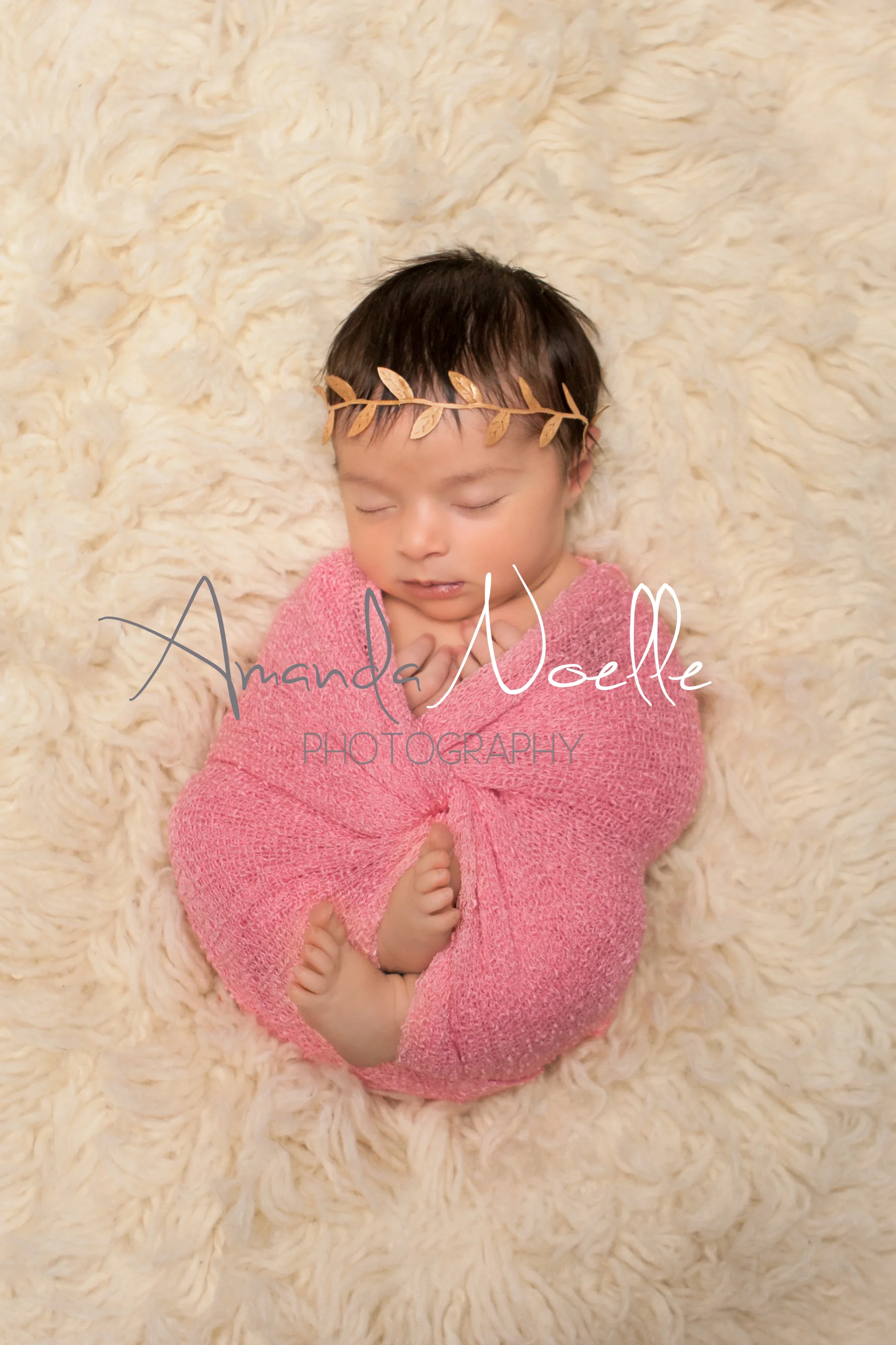 Newborn baby girl sleeping with gold leaf headband wrapped in stretch knit pink wrap on cream creme flokati rug, Westchester, County New York Newborn Photographer, Amanda Noelle Photography.