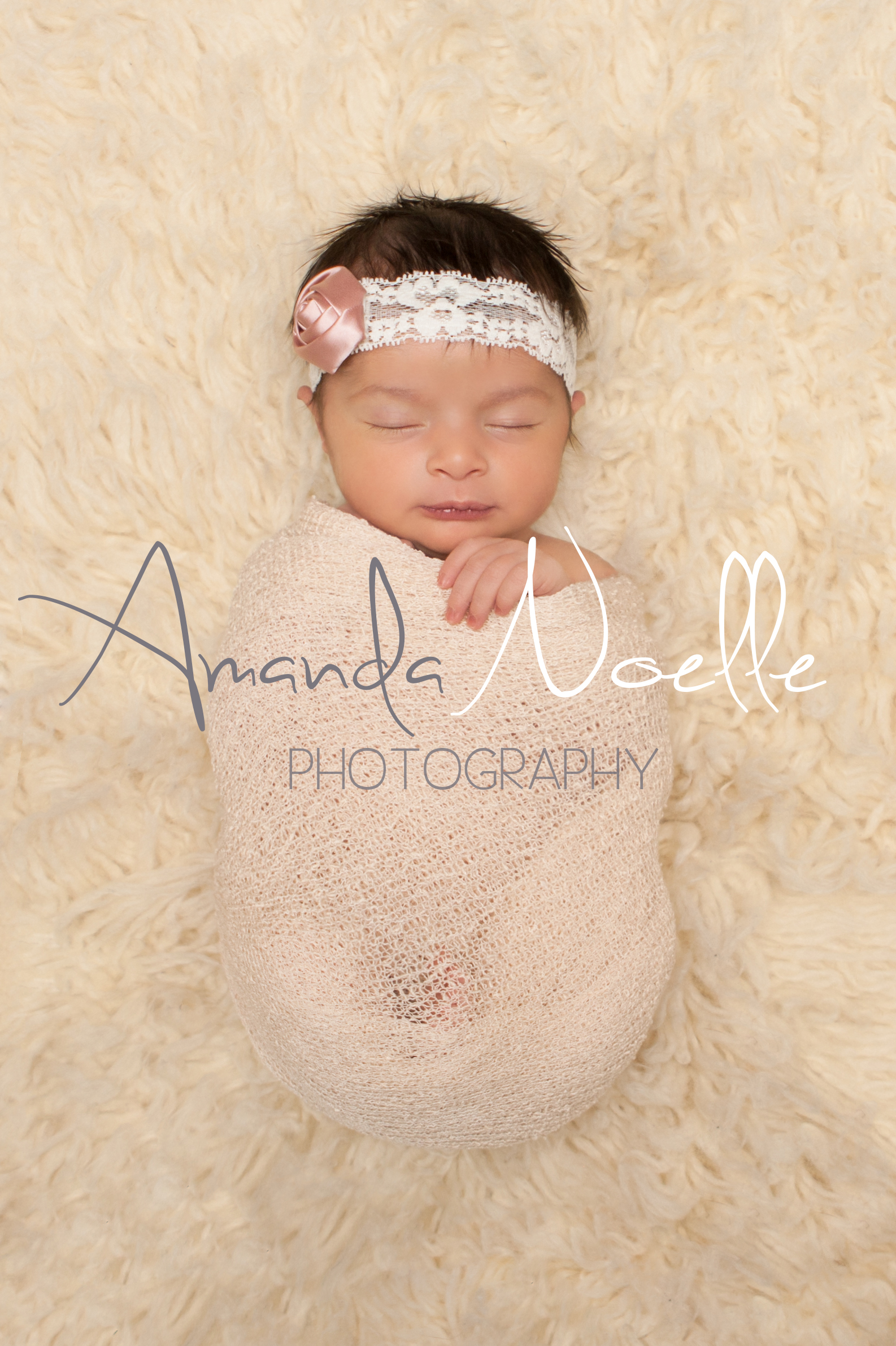 Newborn baby girl sleeping with pink and white lace rose flower headband wrapped in stretch knit cream wrap on cream creme flokati rug, Westchester, County New York Newborn Photographer, Amanda Noelle Photography.