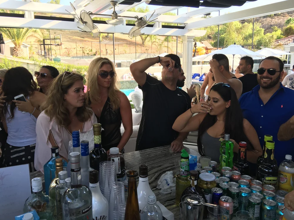 Guests gathered at an outdoor bar served by Platinum Bartenders