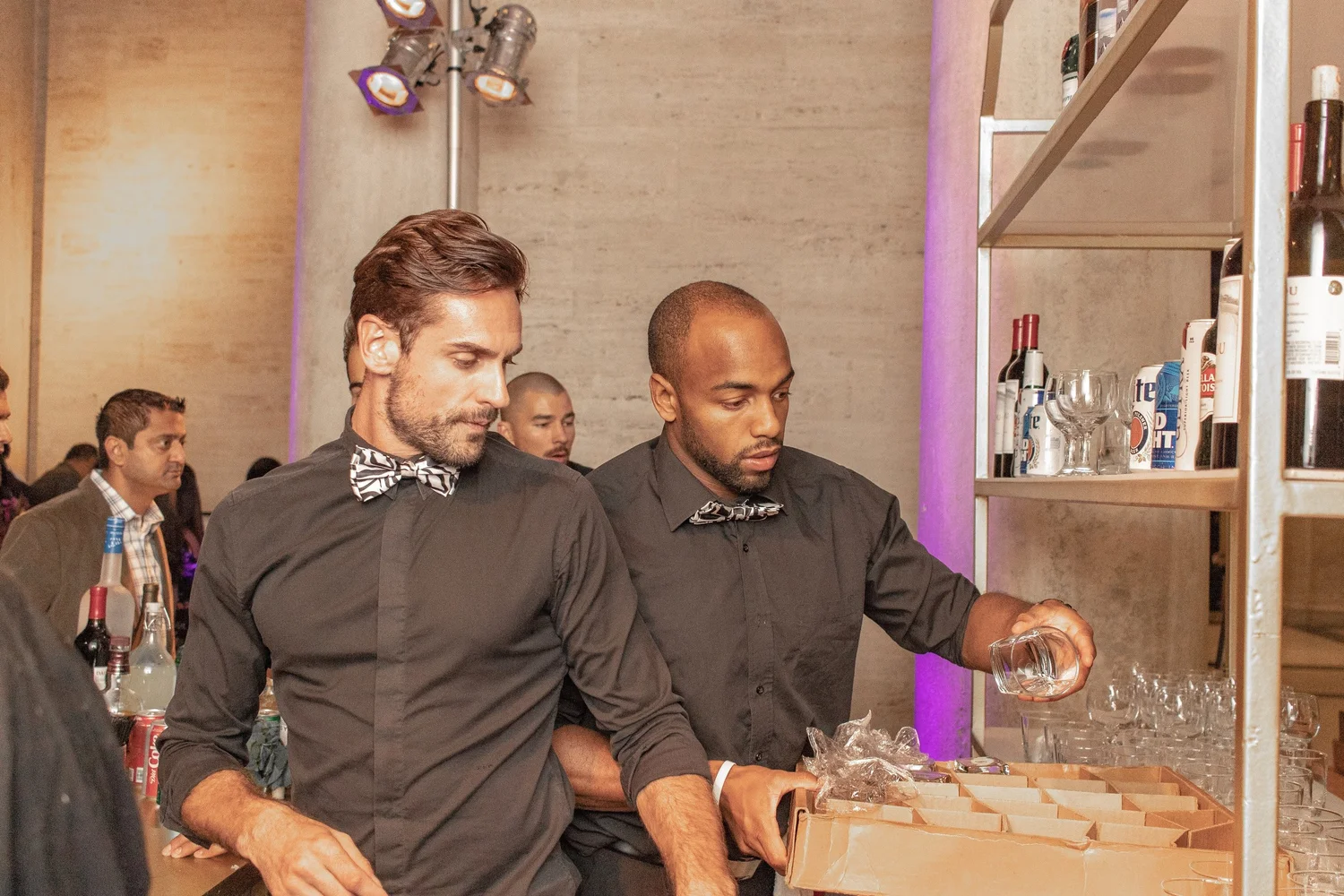 Two Platinum bartenders setting up a bar at an evening event