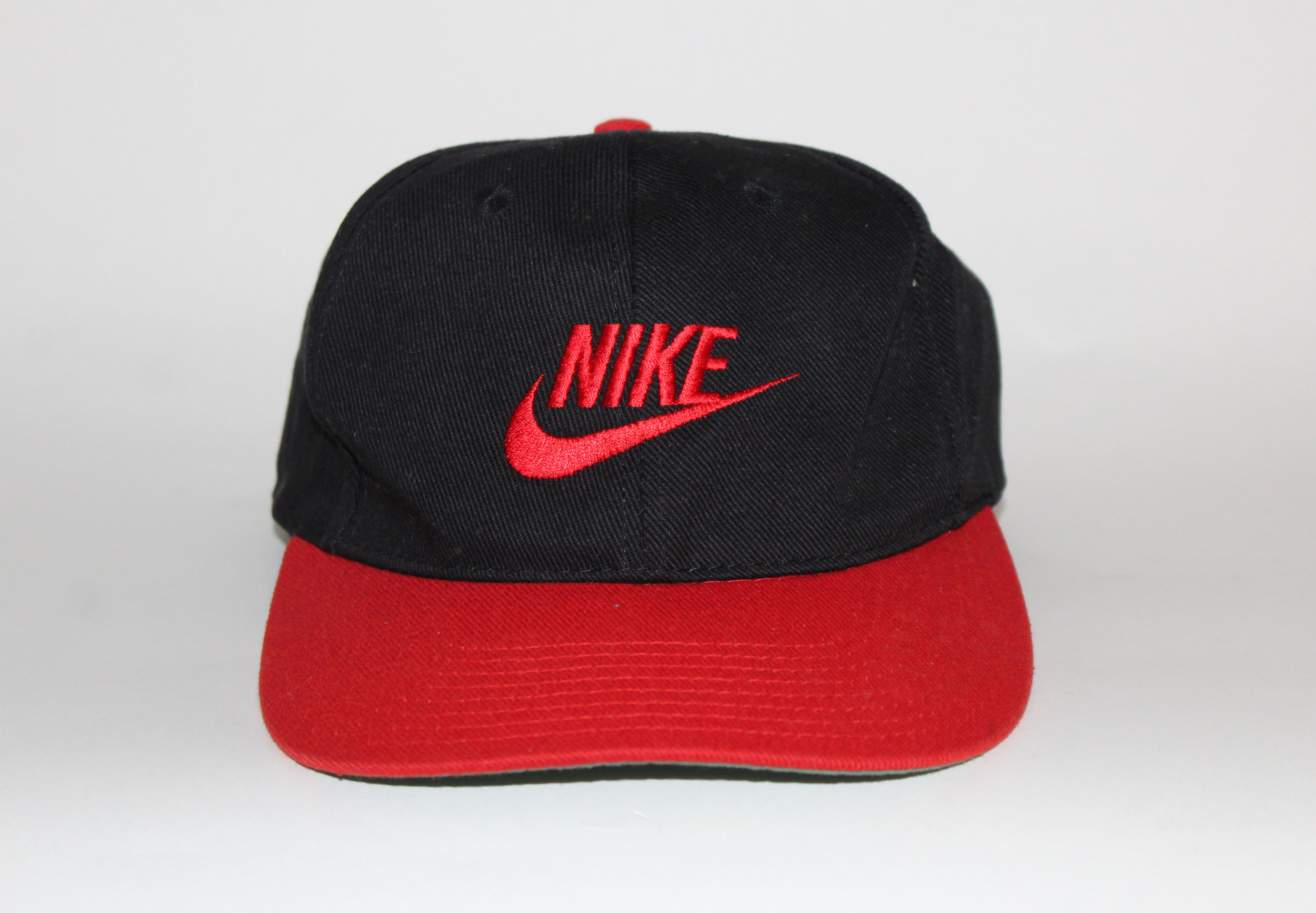 black nike hat with red swoosh