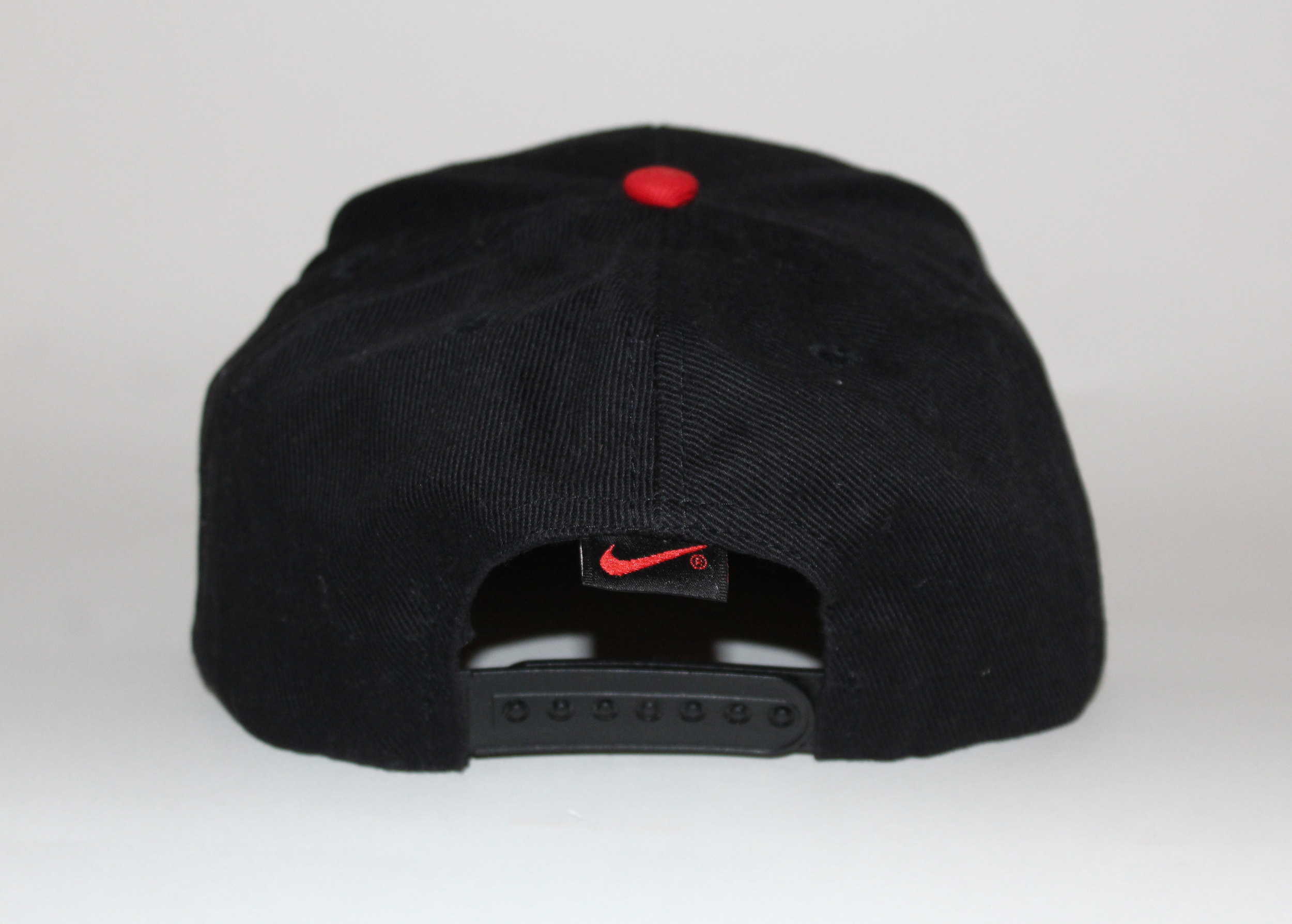 black nike hat with red swoosh