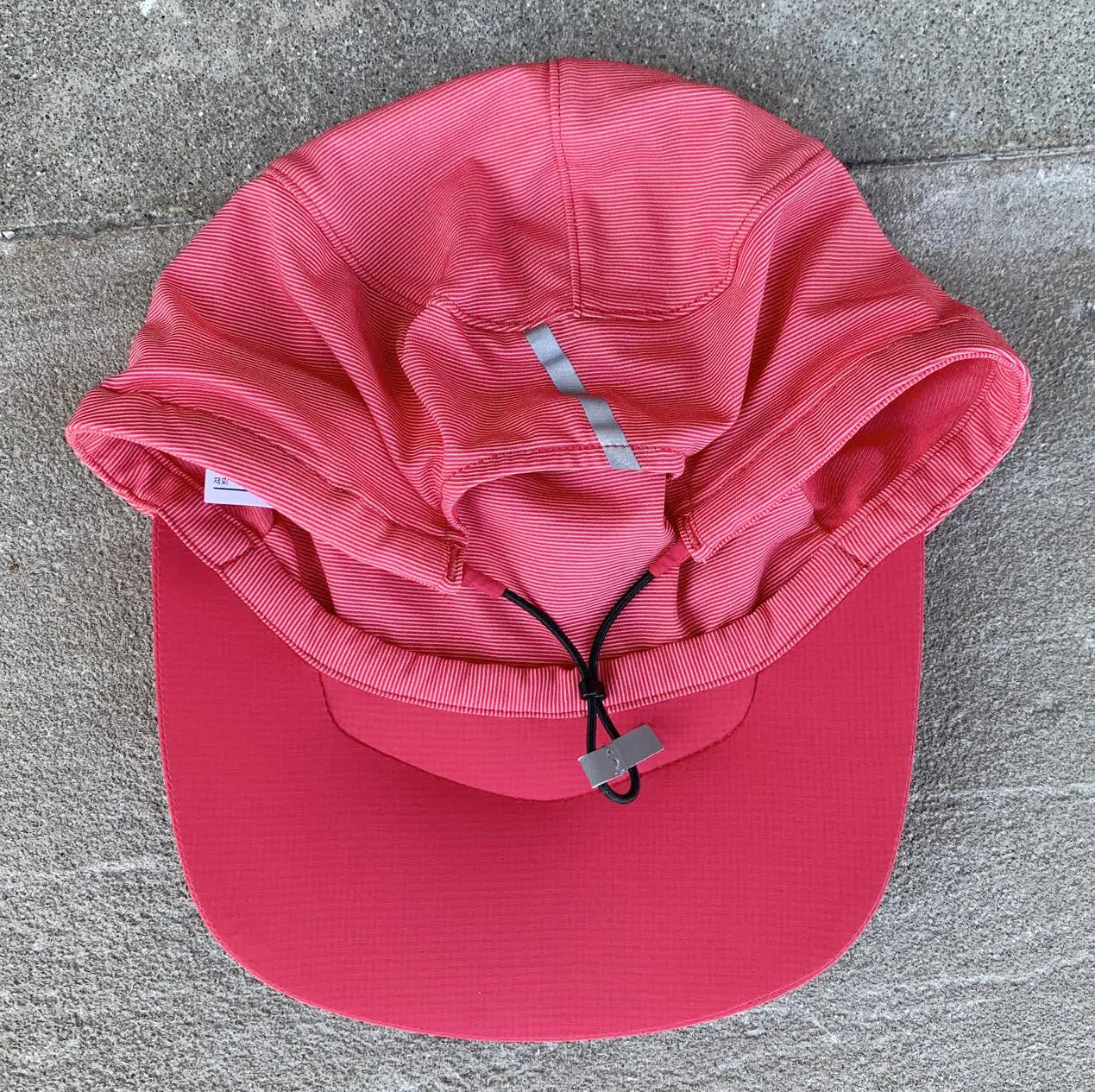 Arc’Teryx Incendo red and pink hat. 