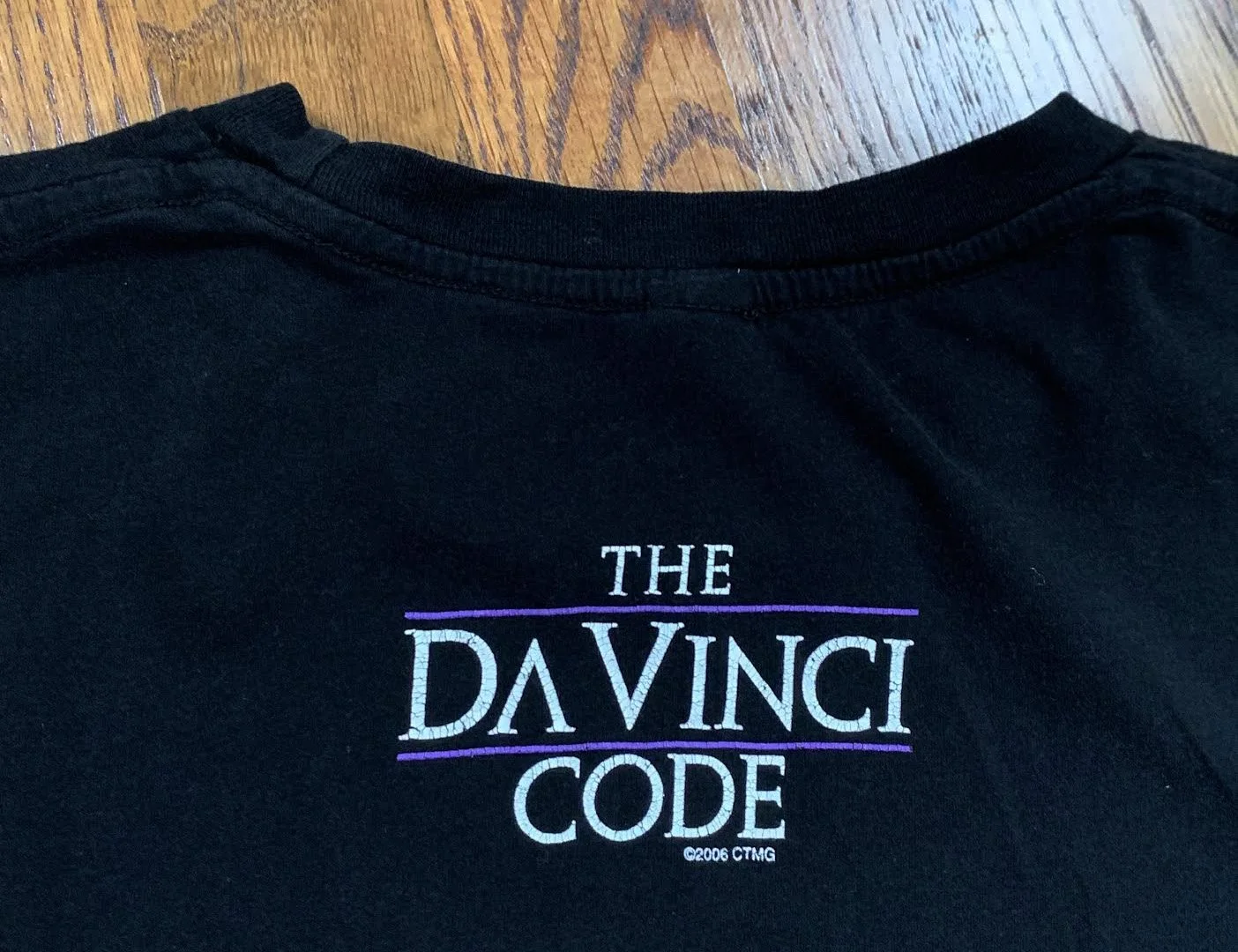 The Da Vinci Code “So Dark The Con Of Man” Black/ Purple T Shirt 