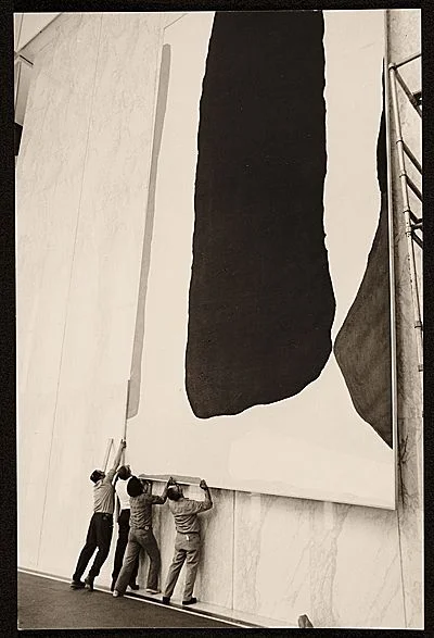 A crew installing Helen Frankenthaler’s painting 'Guiding Red', 1977