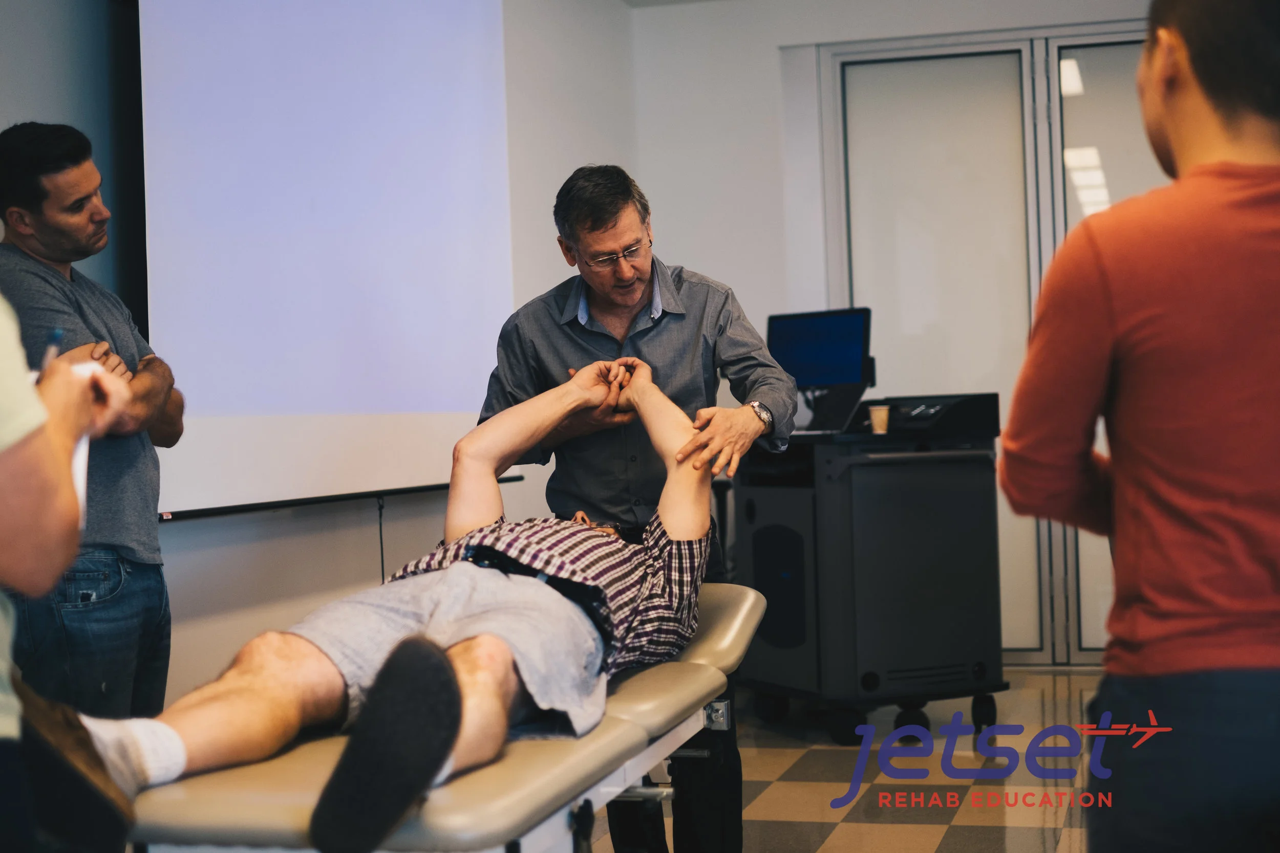Michael Shacklock observes and palpates the Ulnar nerve. One can observe differences when comparing sides if one area has inflammation. 