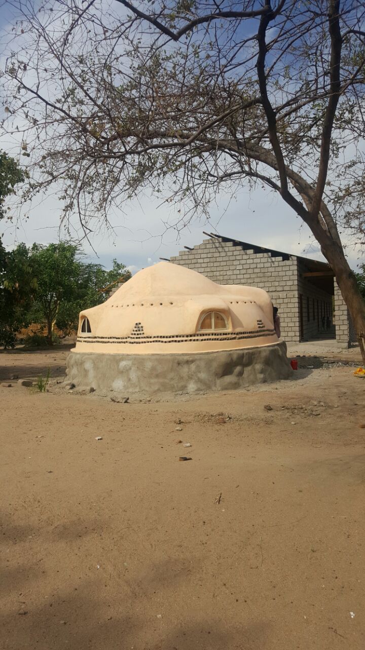 Construction aligned with nature, a permaculture rammed earth school project in Malawi with her service work team - makeaworldofdifference.org 