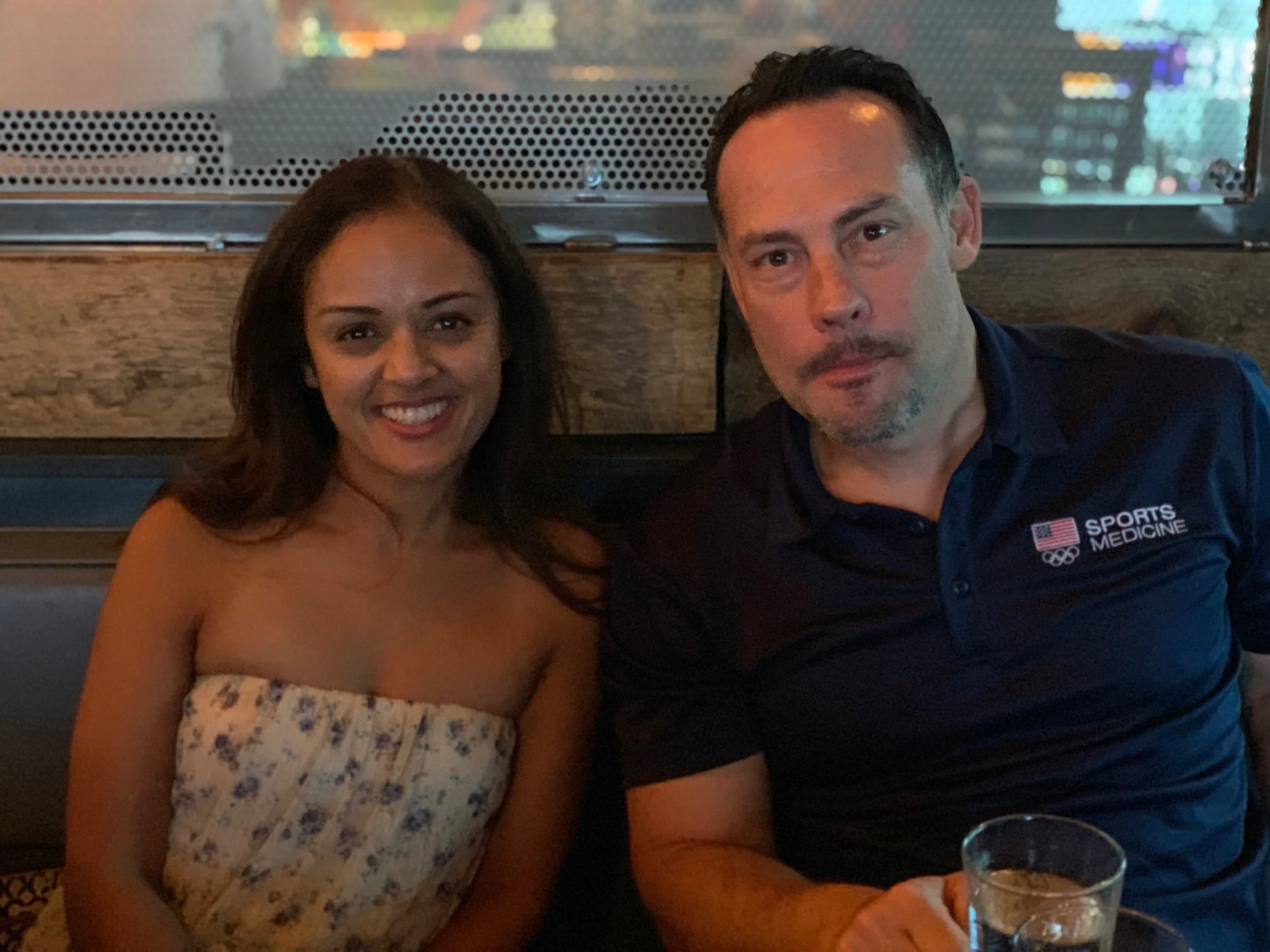 Priti and Johnny Owens chatting over a beer.