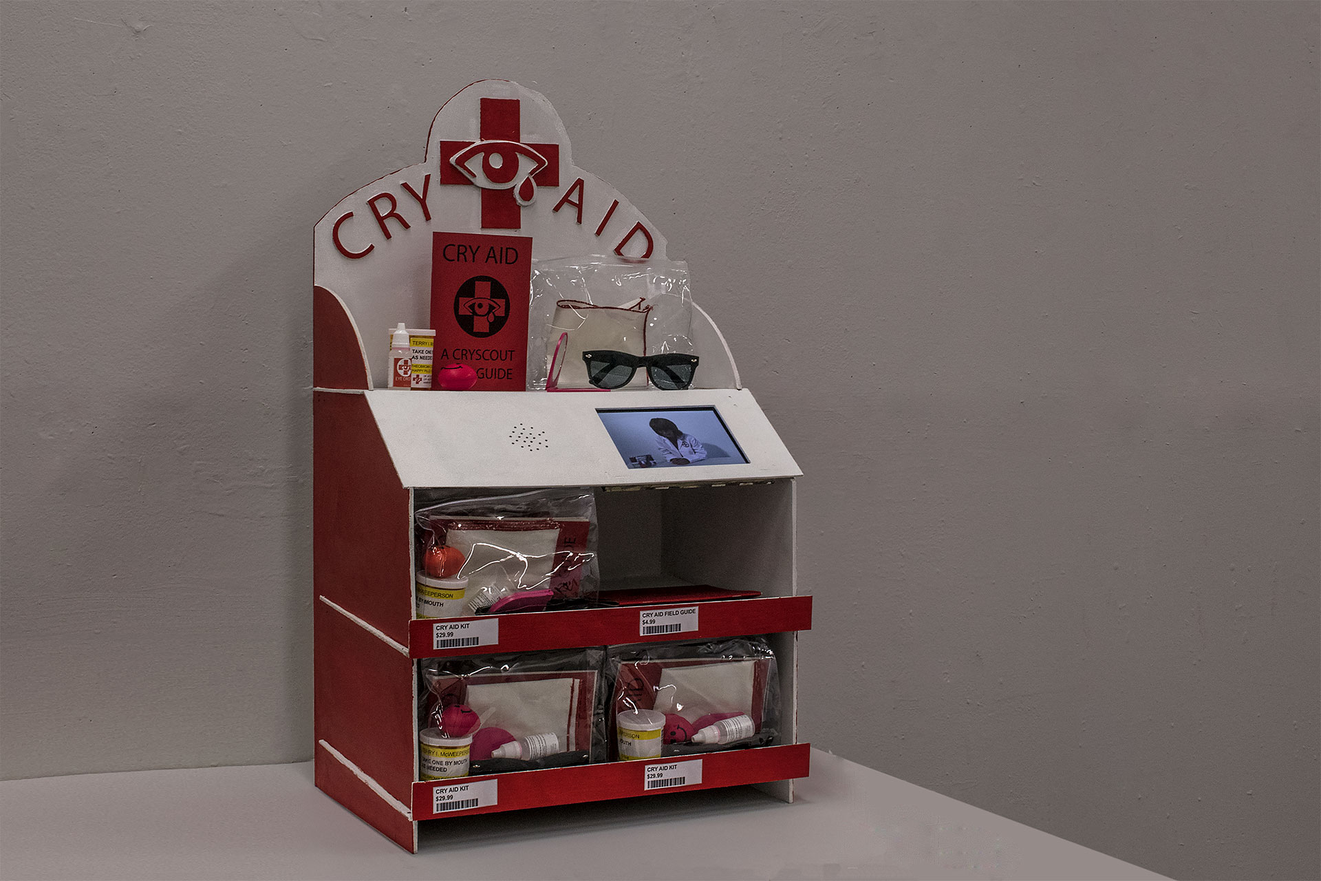   Cry Aid Display    8 min looping infomercial, Cry Aid Kits, Cry Aid Field Guides, wooden display, price tags  32" x 19" x 13"  2017. 