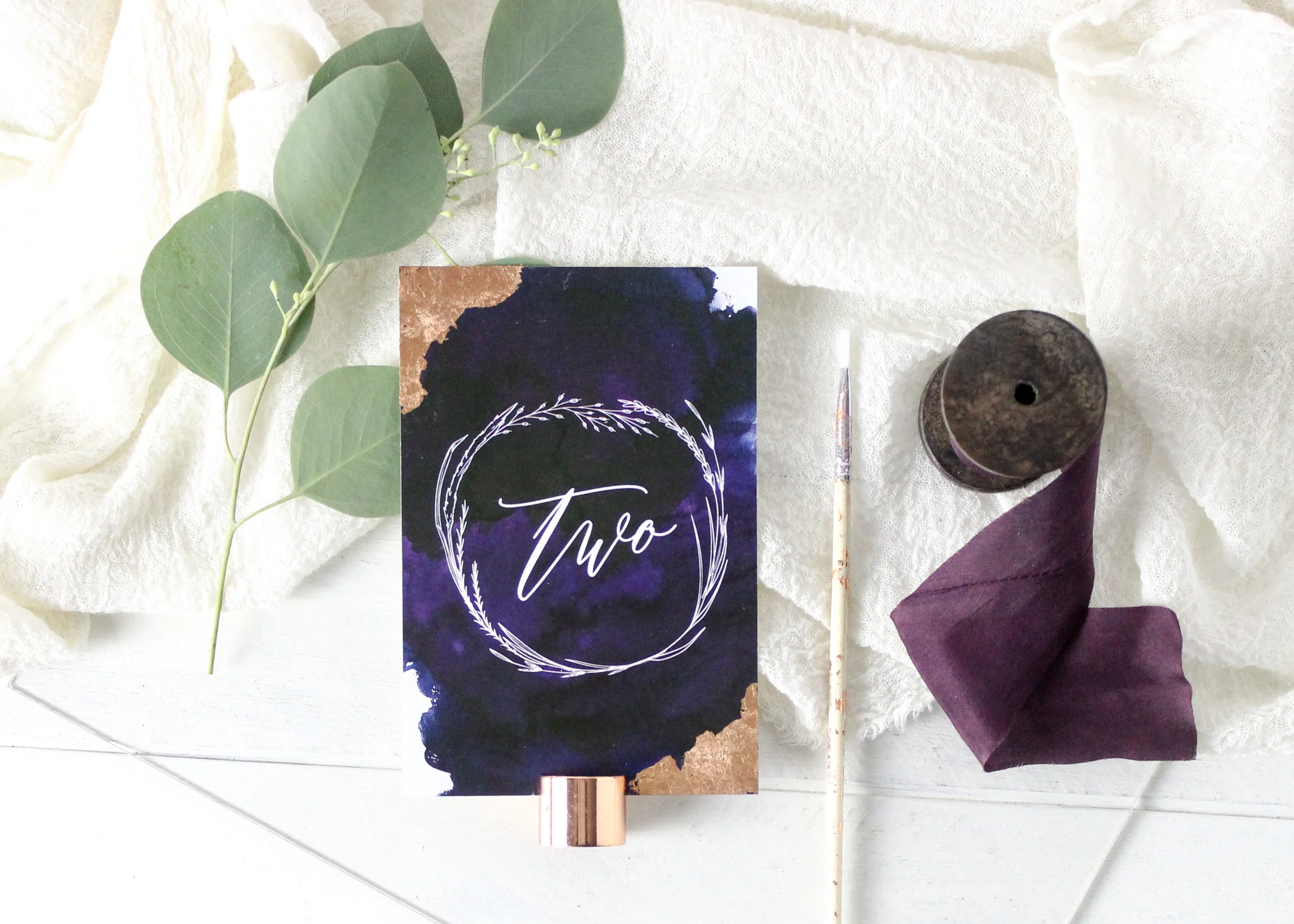 Gilded Accent on Table Numbers