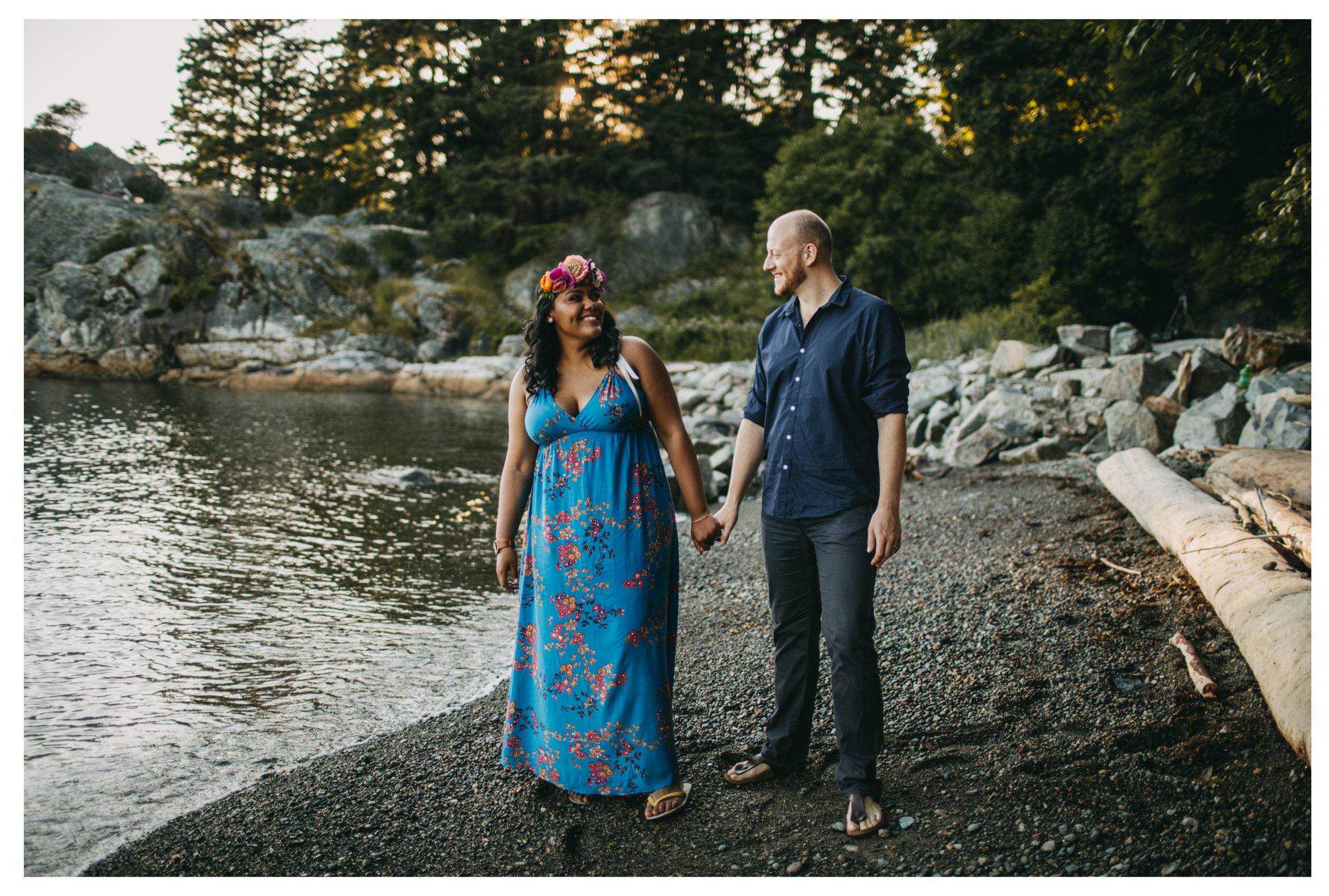 engaged couple holding hands laughing beach engagement whytecliff park sunset