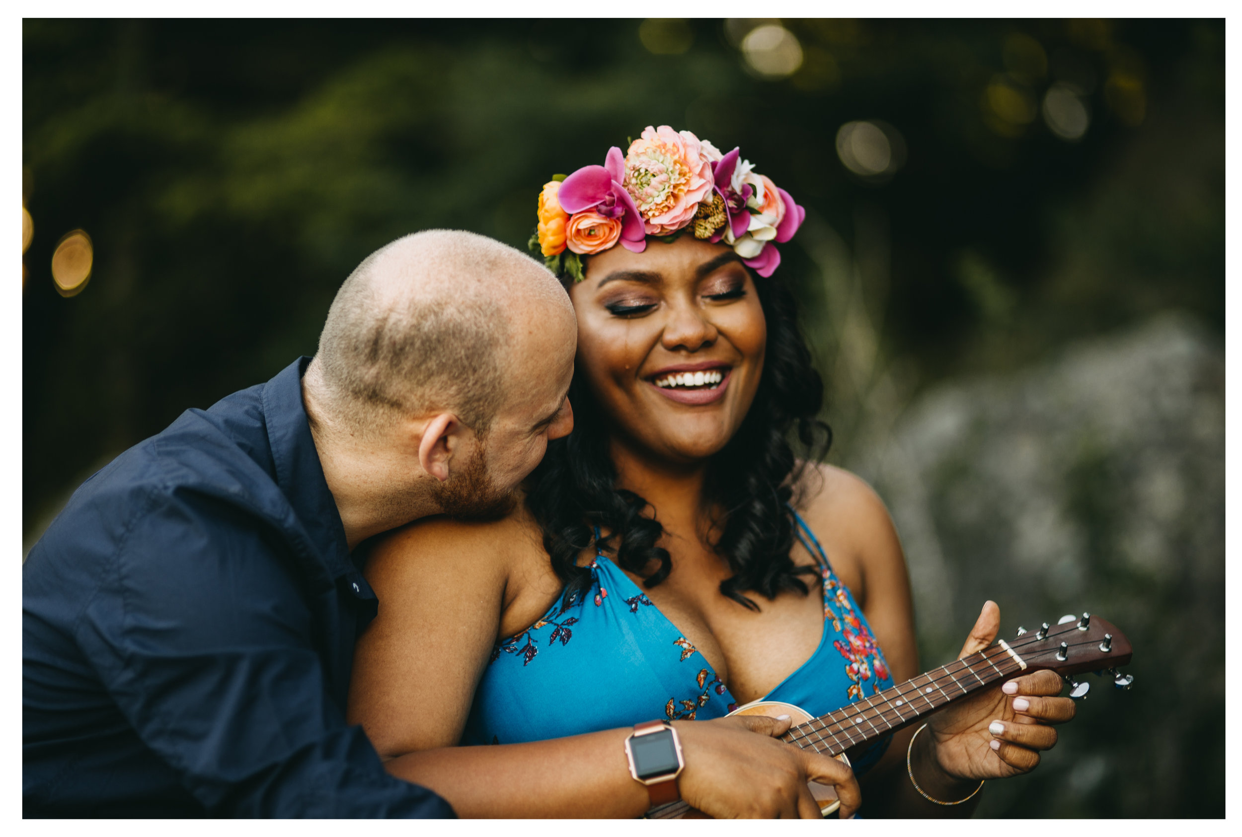 engaged couple playing ukulele while girl cries happy tears