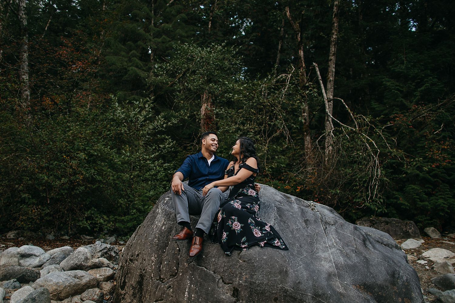 Copy of couple sitting on rock laughing engagement photos