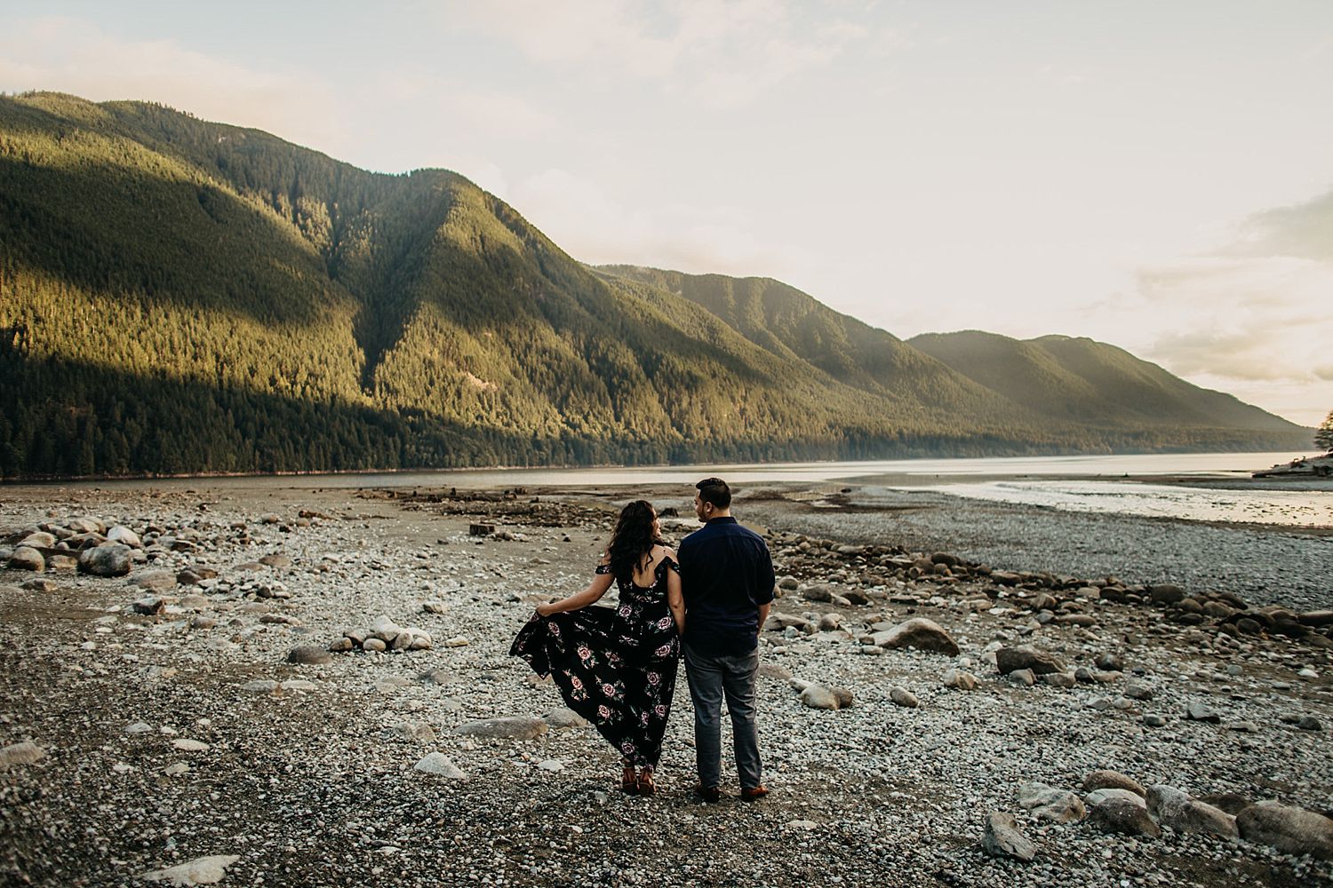 Copy of couple standing on beach alouette lake dress flowing in wind