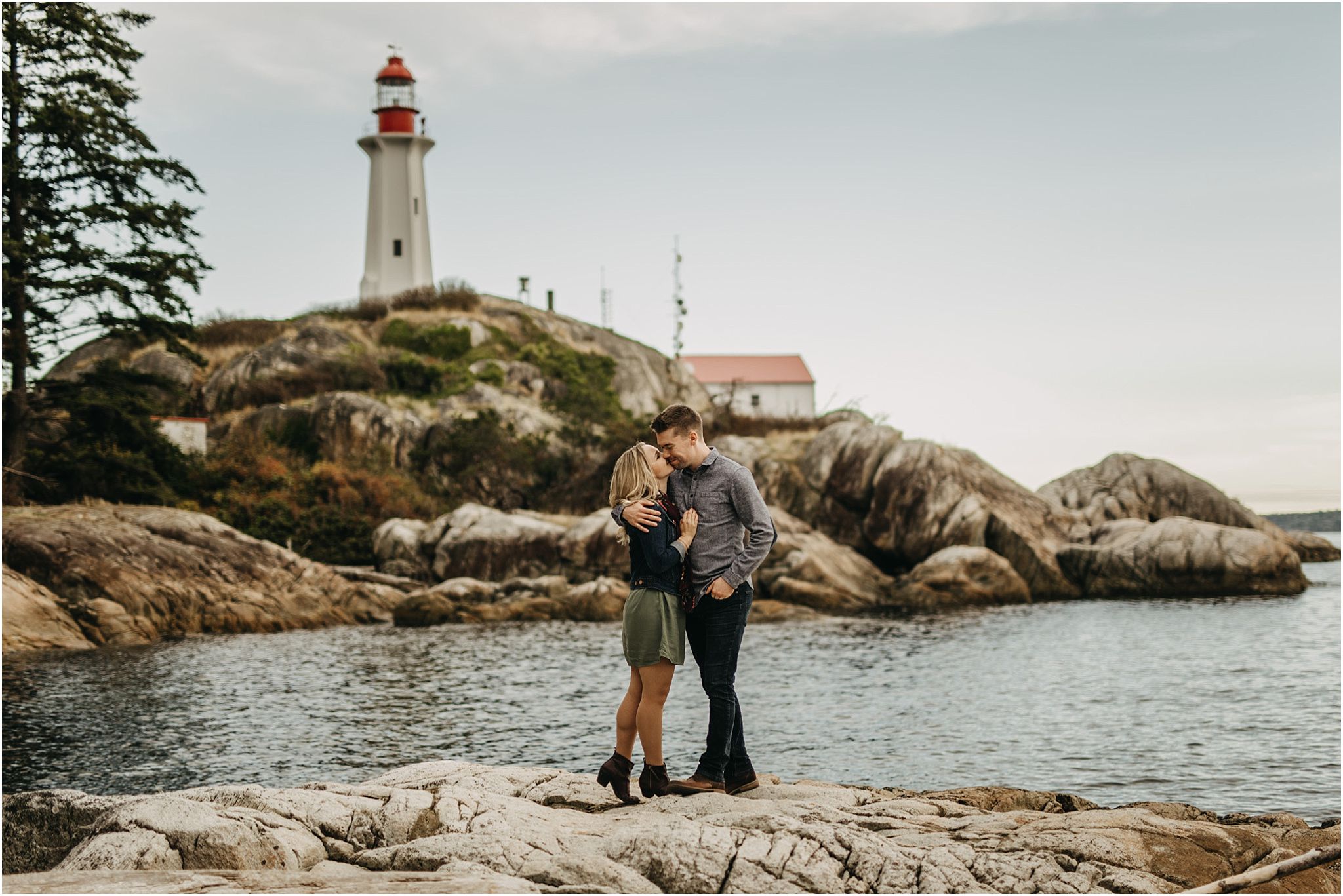 couple kissing on cheek fiance lighthouse park