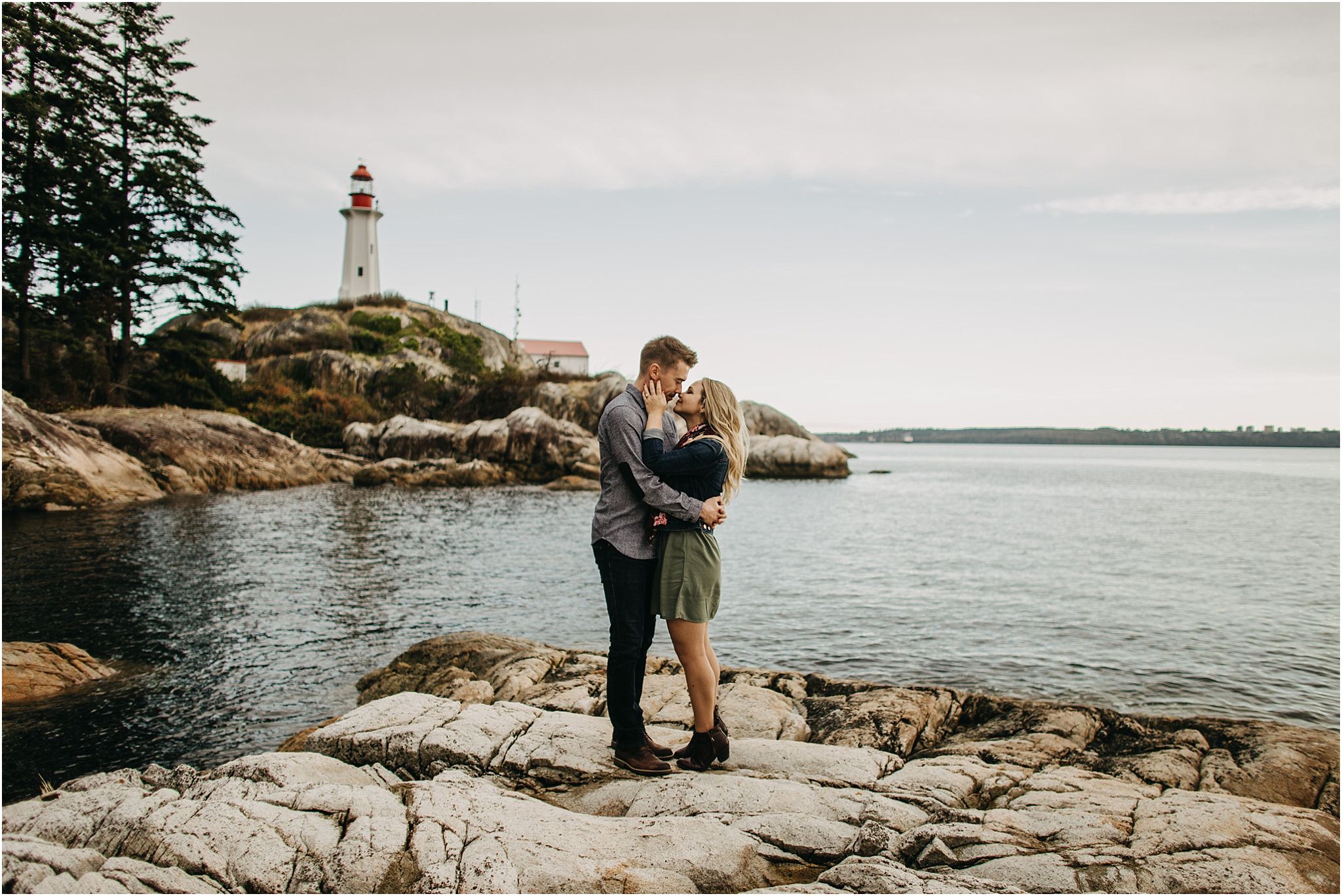 couple kissing on beach at lighthouse park