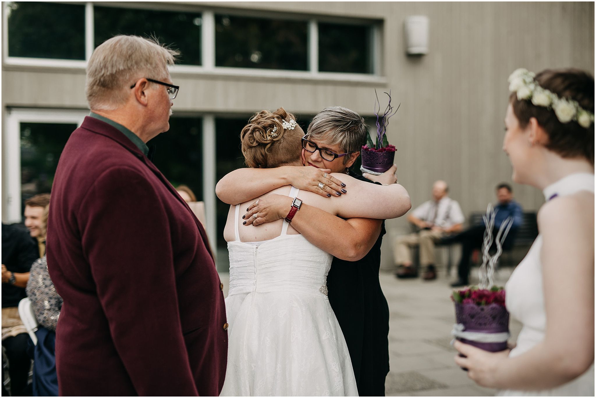 mother of bride hugging bride wedding ceremony