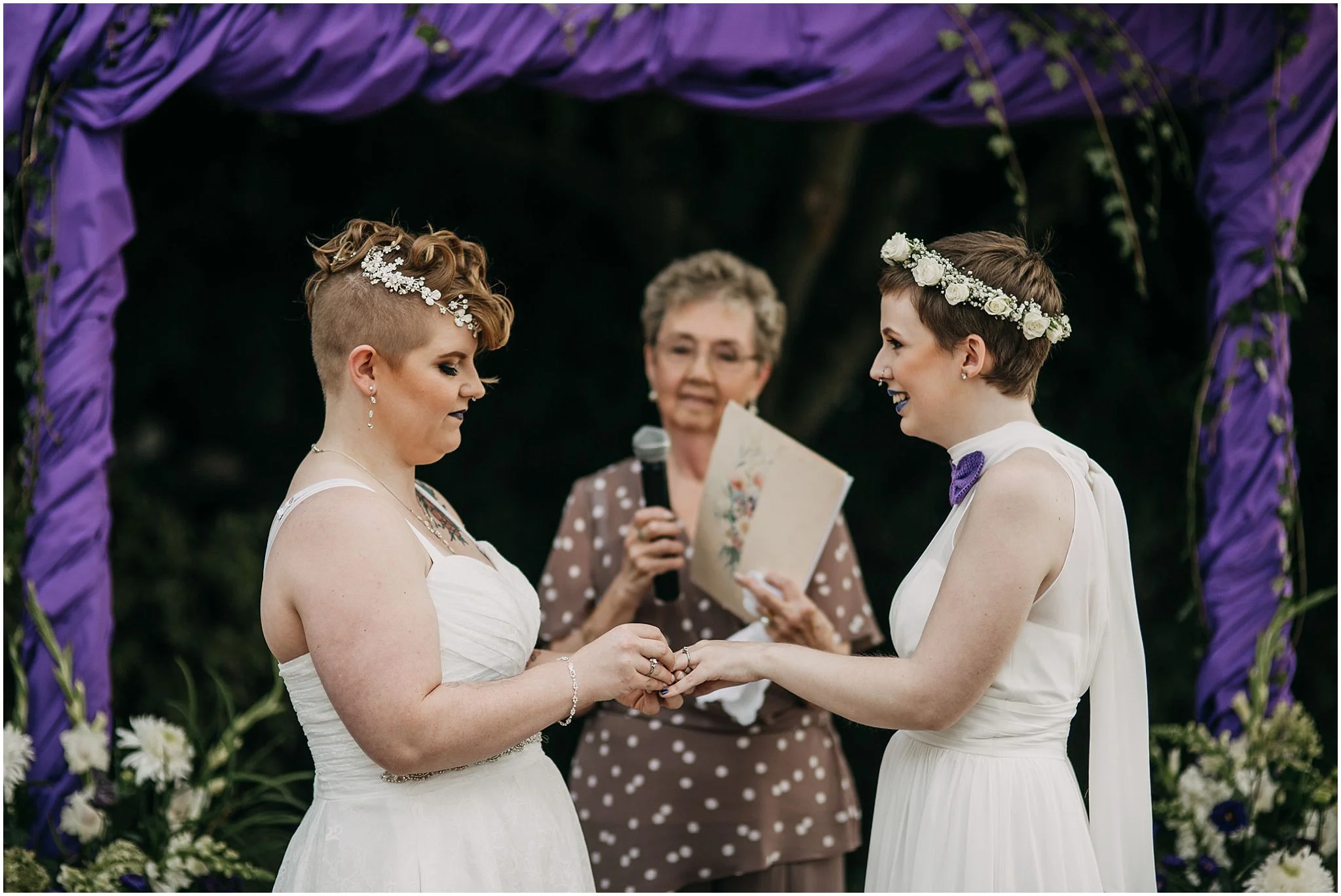 same sex couple exchanging rings wedding