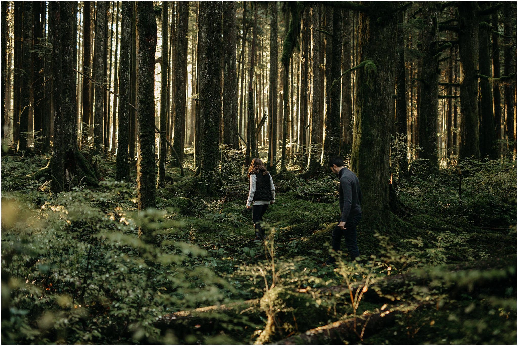 couple walking into mossy forest engagement photos