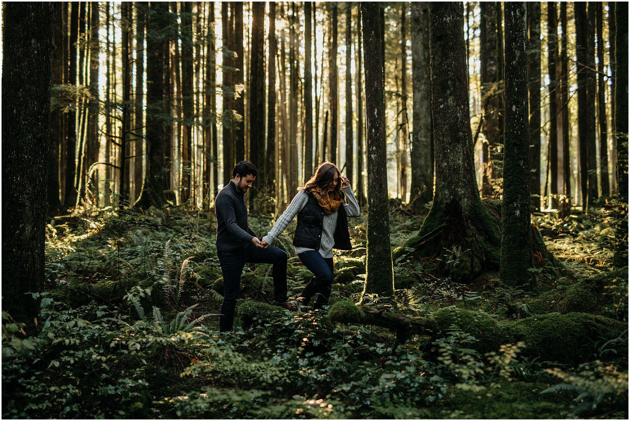 girl leading guy out of forest engagement photos