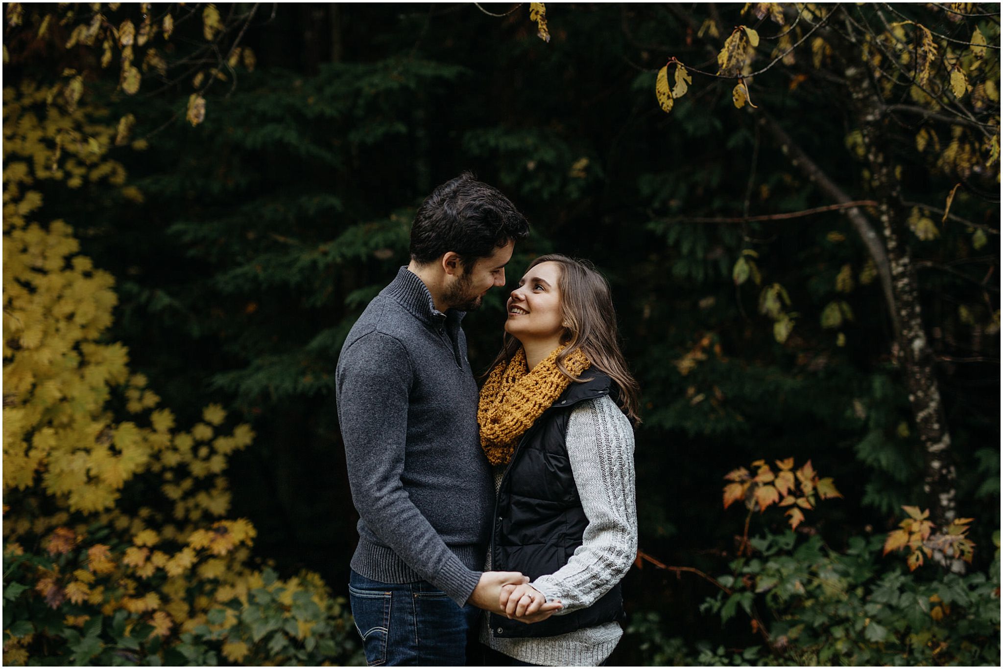 couple holding hands fall leaves autumn colours engagement session