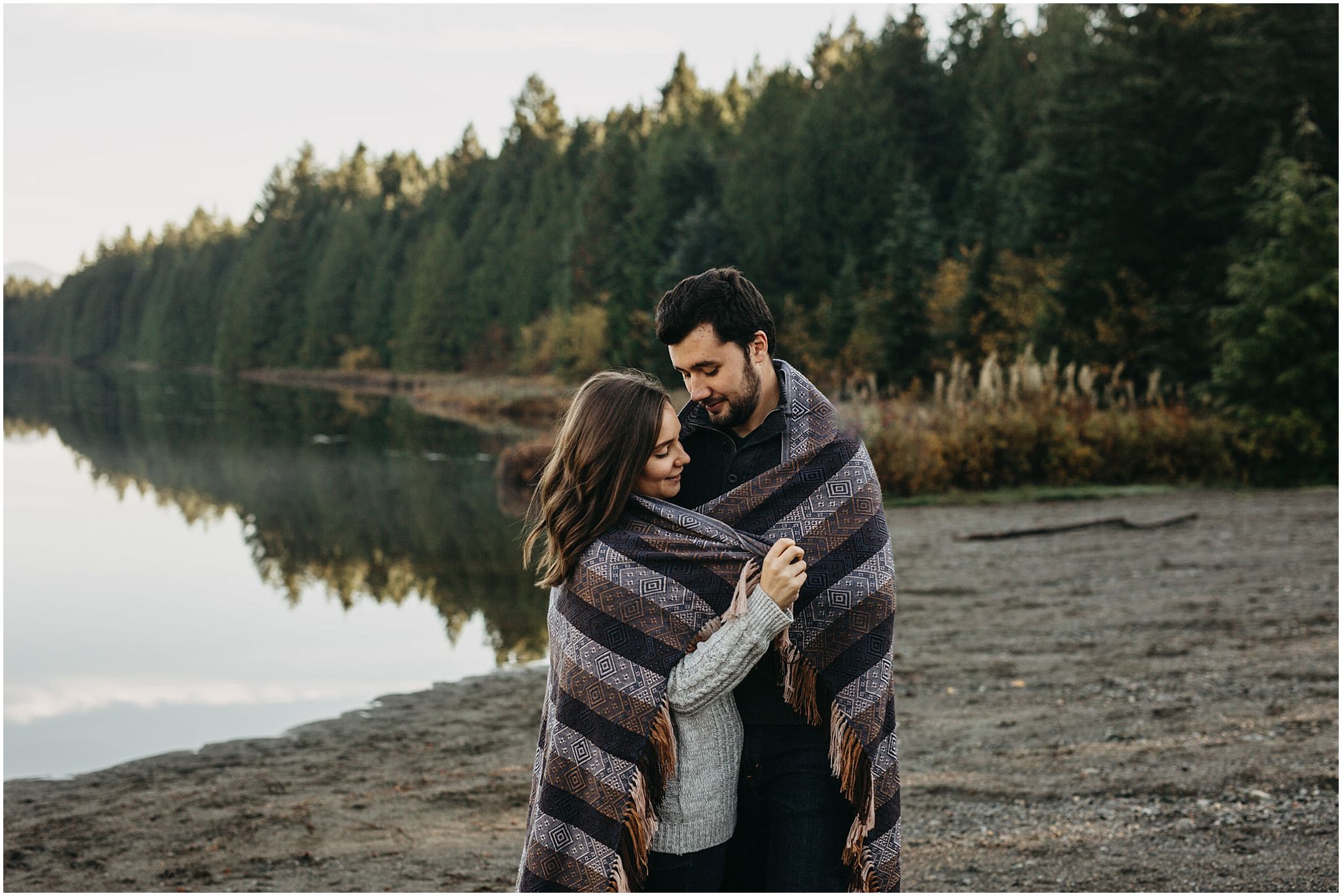 couple wrapped in blanket engagement photos fall autumn