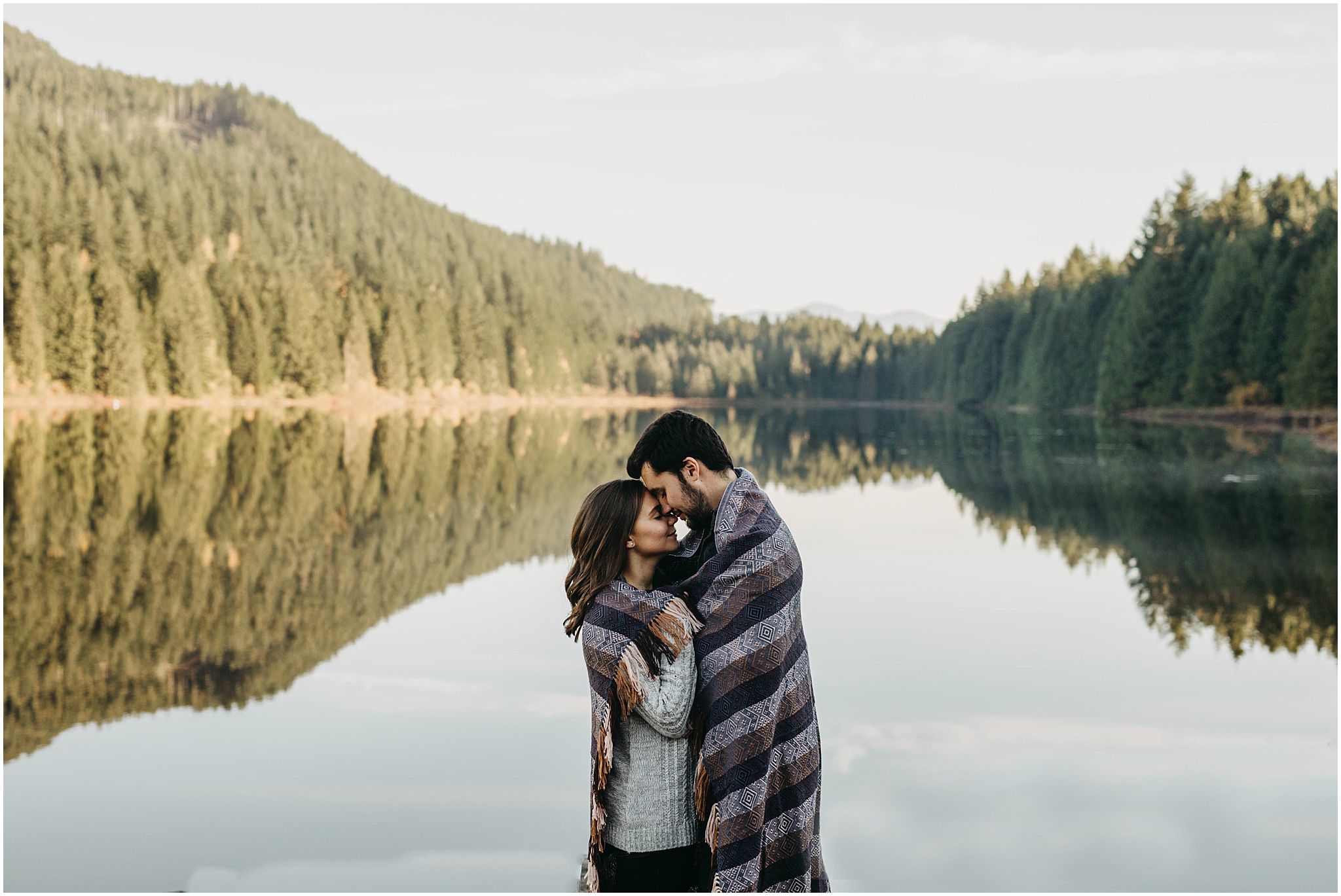 fall engagement photos rolley lake couple wrapped in blanket