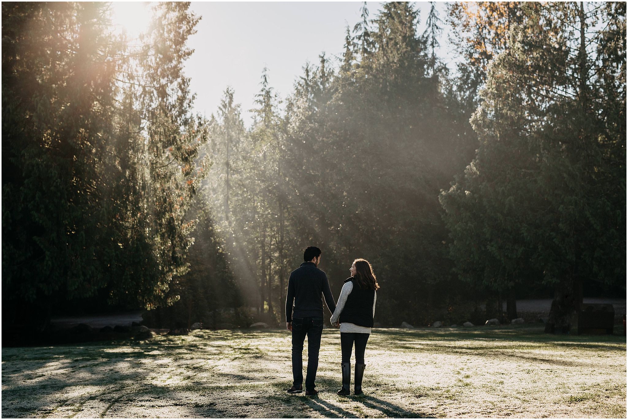 couple engagement session sunshine beam through trees