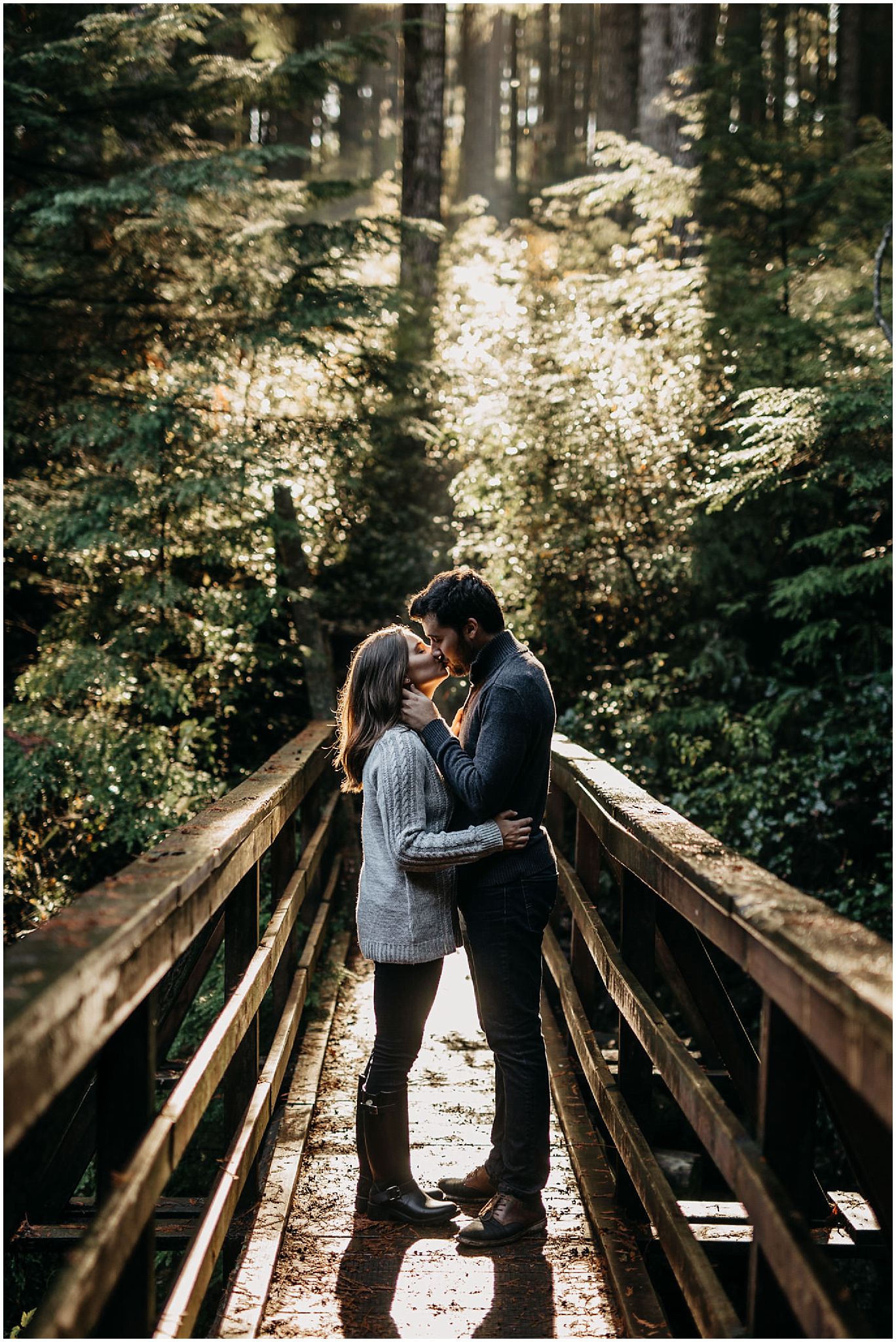rolley lake engagement session sun shining through forest couple kiss