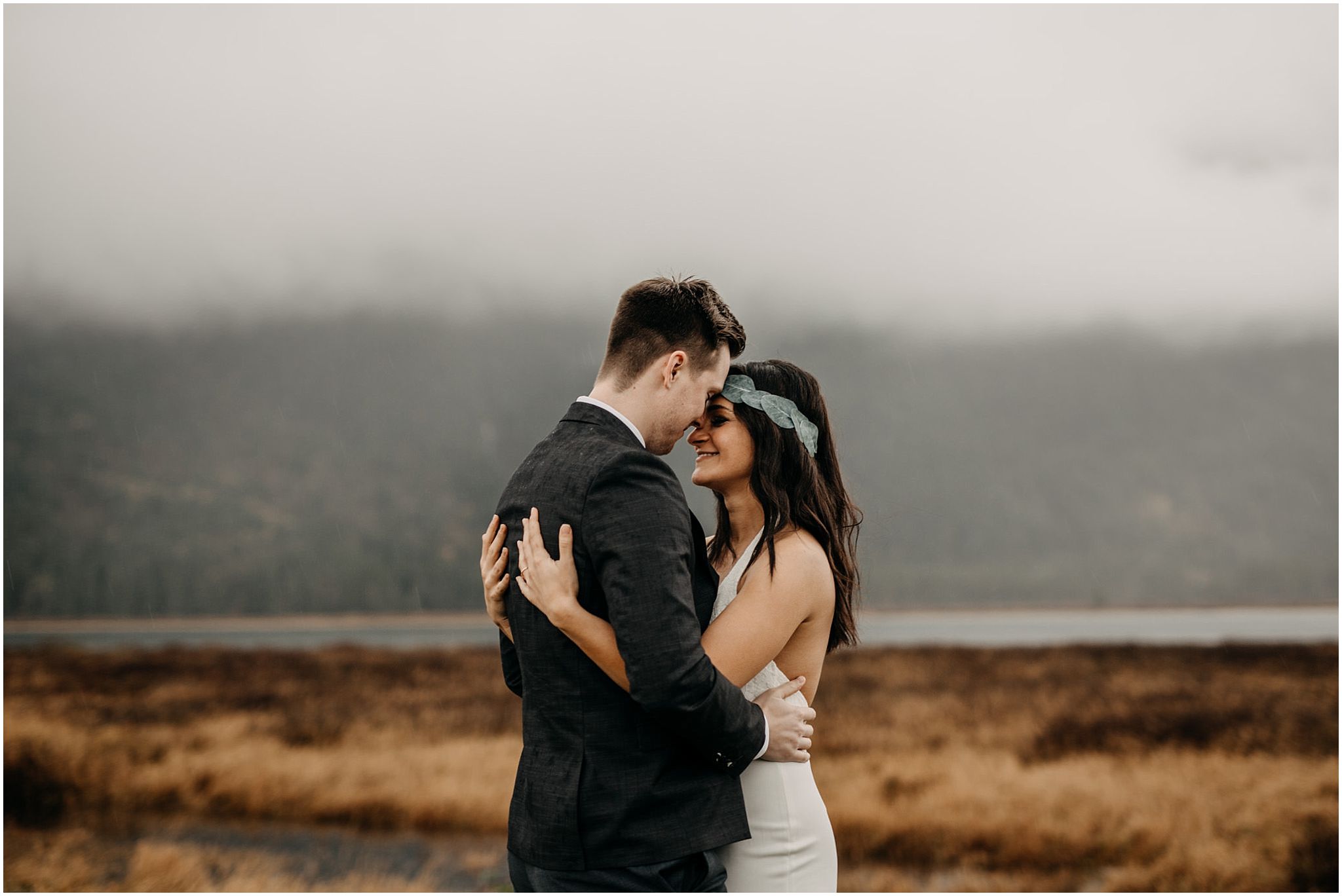 couple hug foggy pitt lake engagement photos
