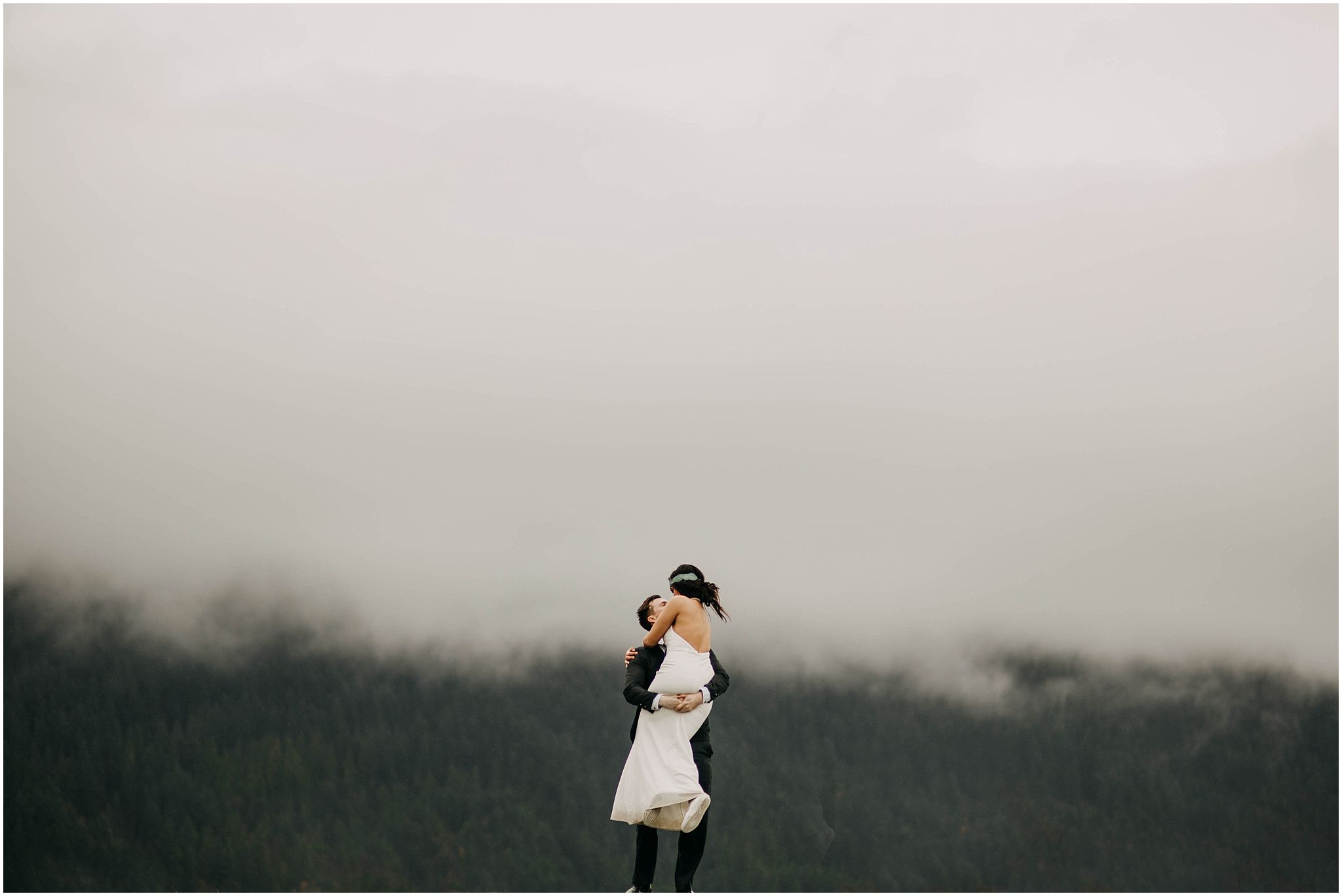couple spinning around foggy cloudy minimal pitt lake engagement