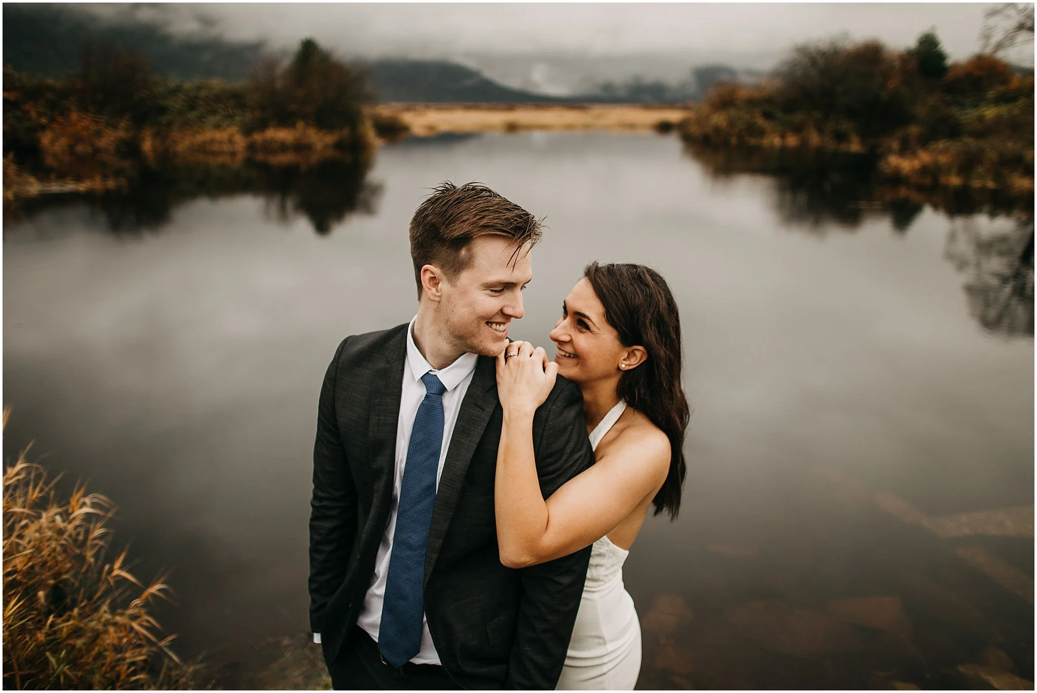 girl's arm draped over guy smiling couple pitt lake engagement
