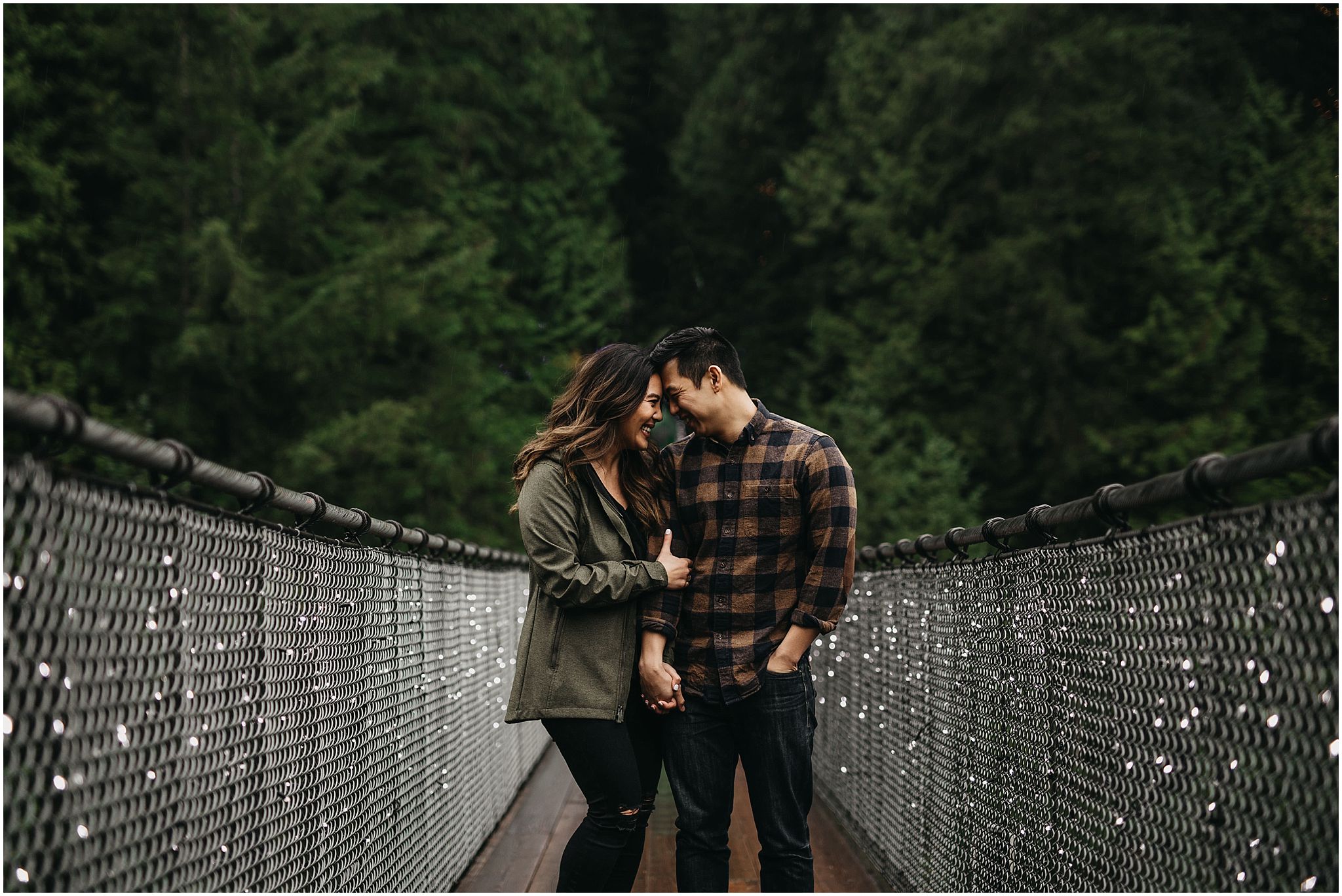 engaged couple on capilano suspension bridge engagement photos
