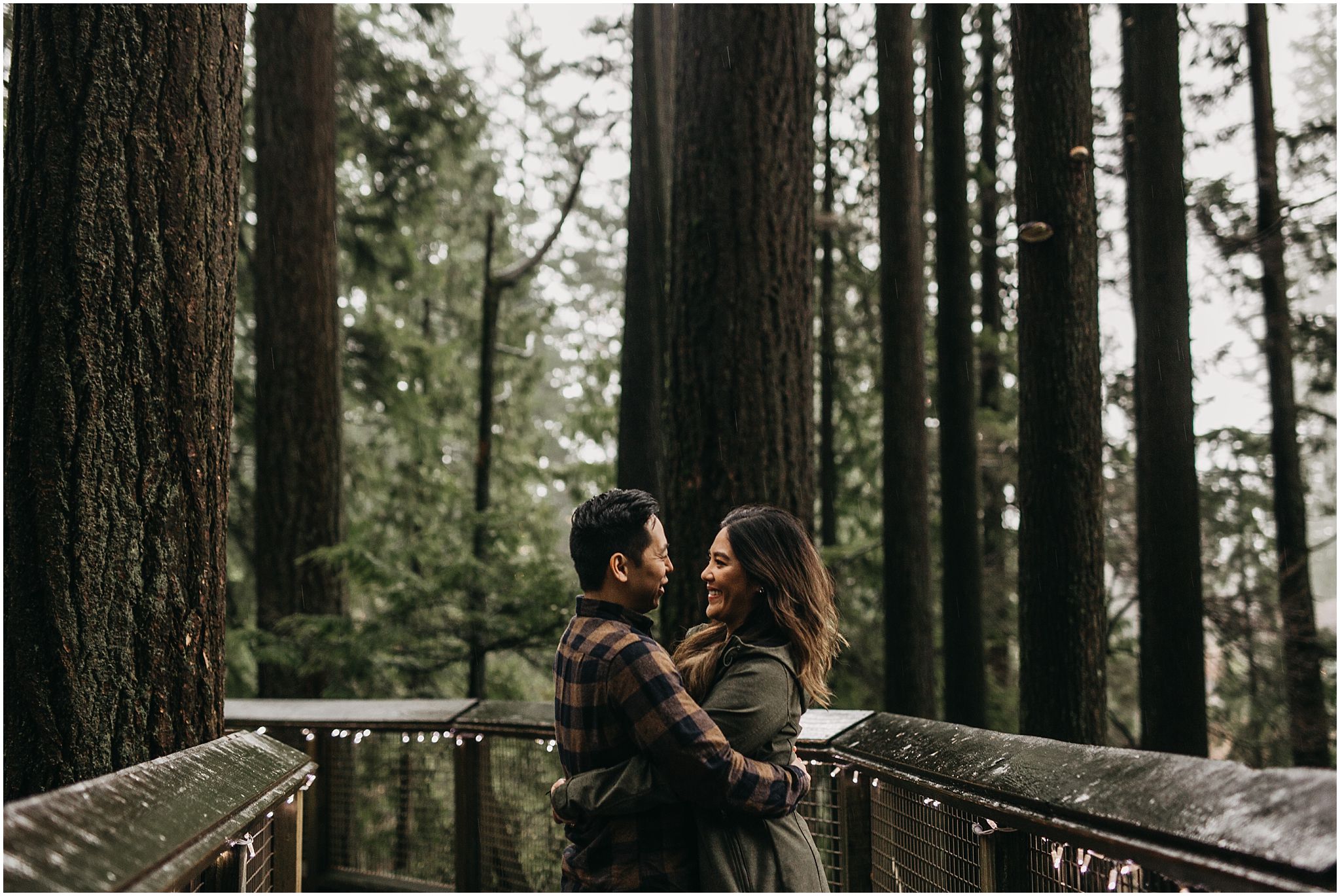 engaged couple capilano suspension bridge nature walk trees