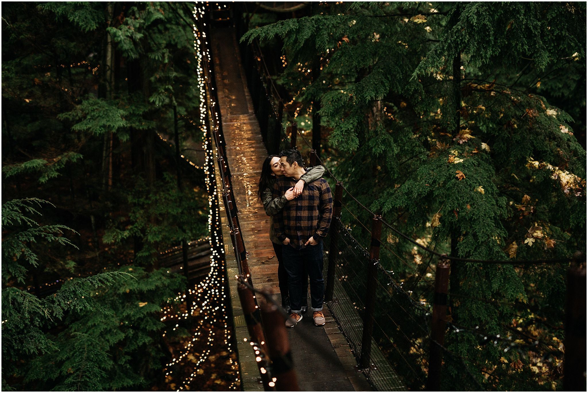 capilano suspension bridge canyon lights engagement photos couple hugging