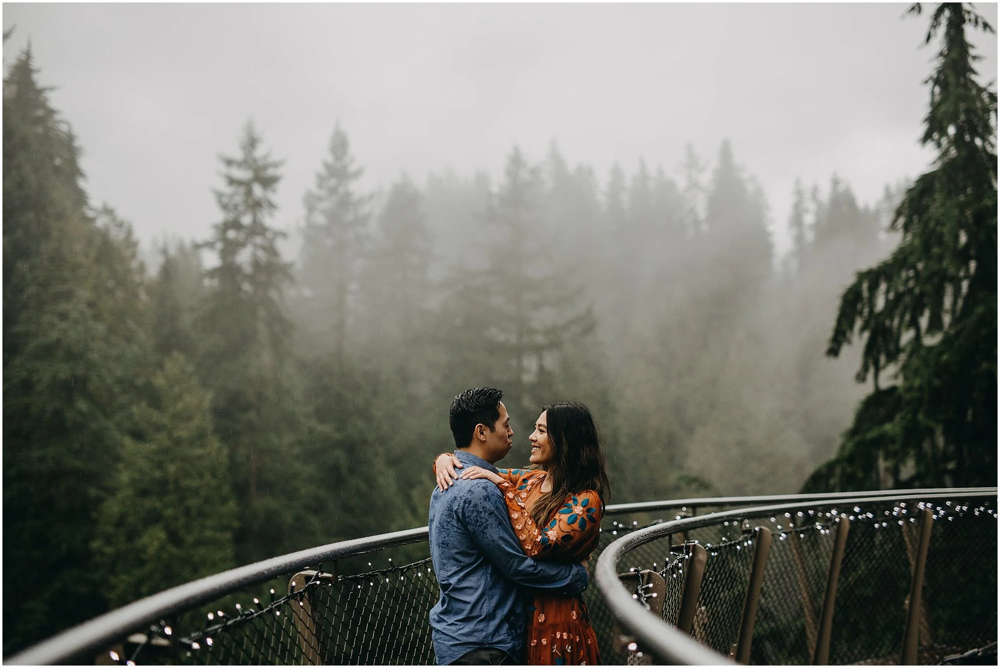 couple intimate moment on cliffwalk capilano suspension bridge engagement photos