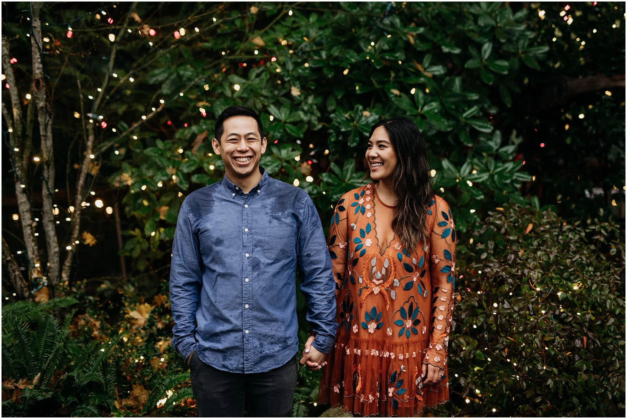 couple holding hands canyon lights capilano suspension bridge engagement