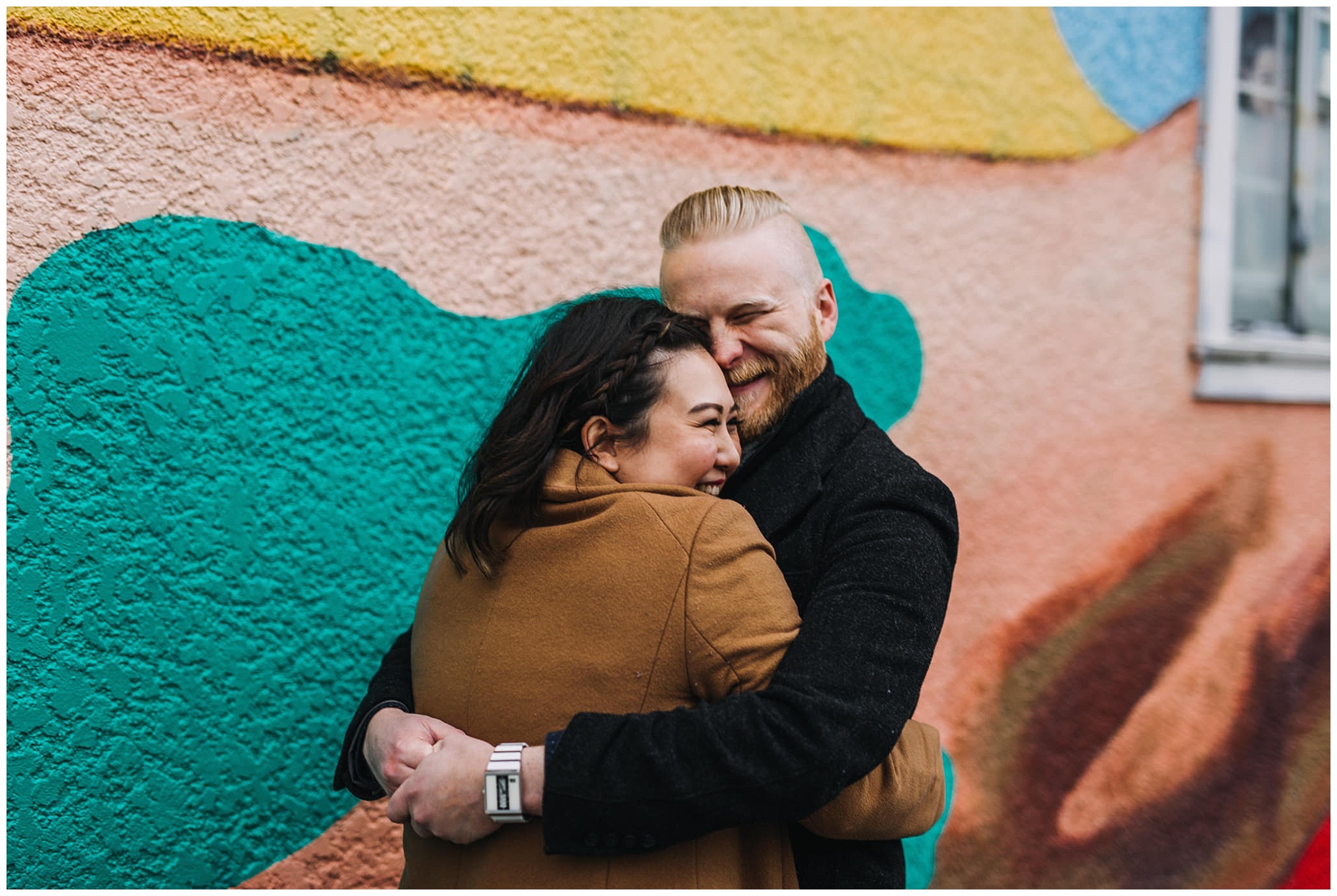 couple hugging at vancouver mural festival engagement photos