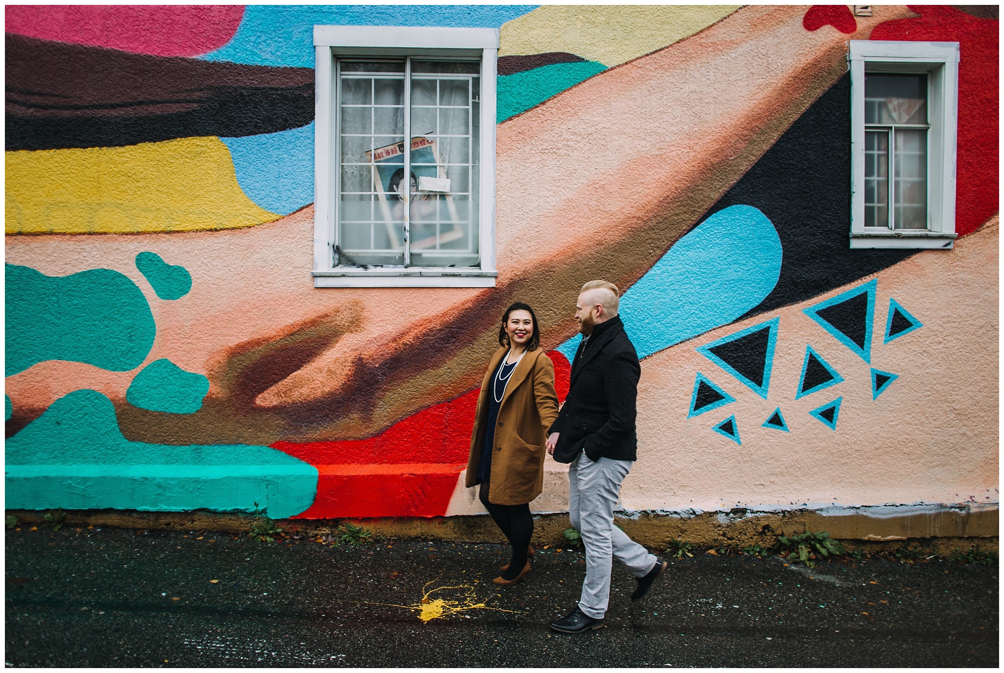 engaged couple walking in front of mural vancouver mural festival engagement photos