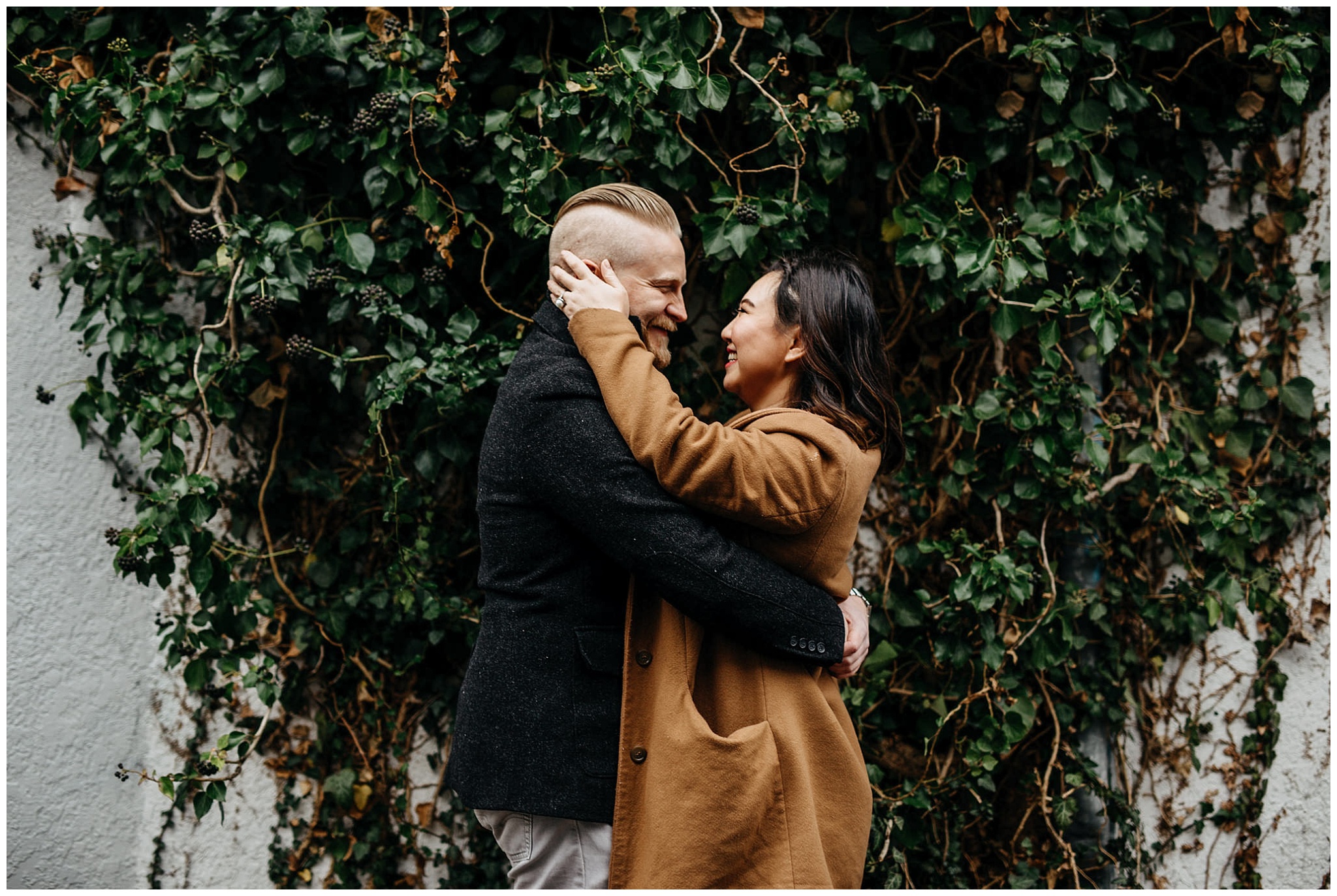 engaged couple in love vancouver alley ivy vine wall engagement