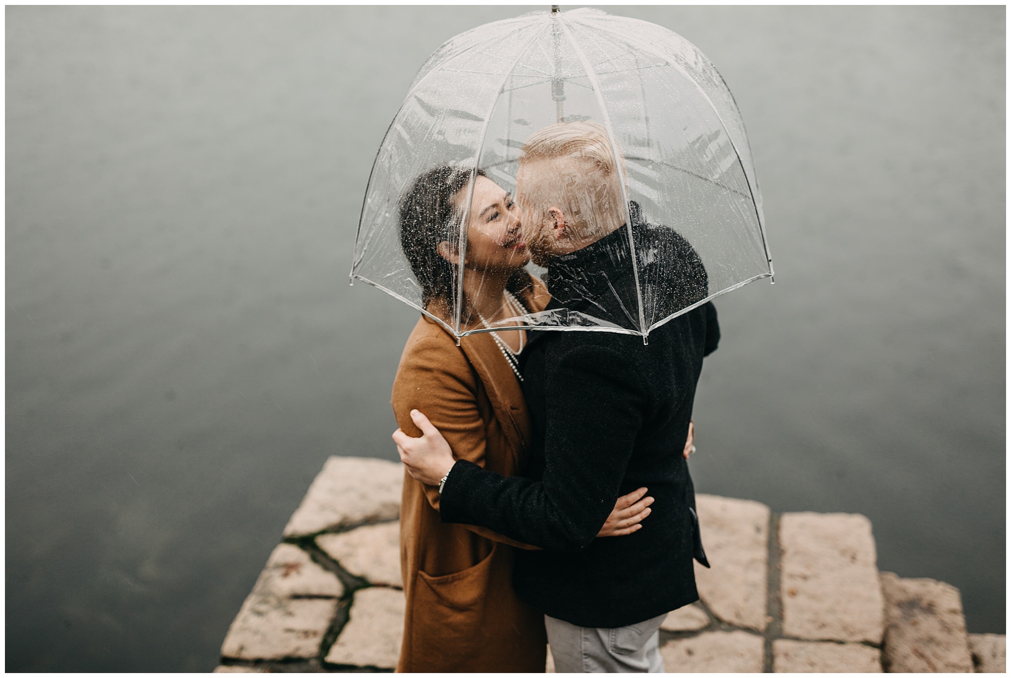 couple engagement rainy day granville island clear umbrella