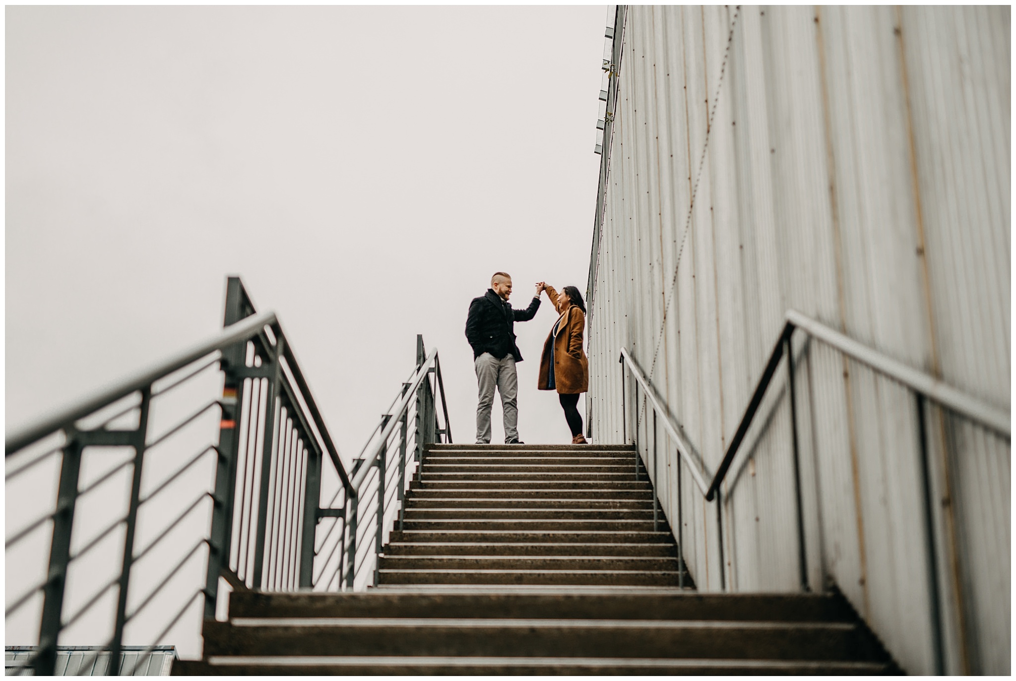 couple dancing on stairs granville island engagement emily carr university