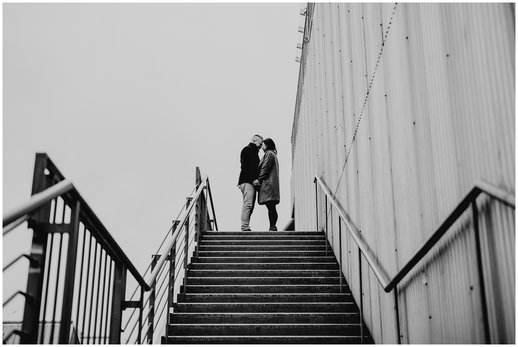 couple at top of stairs granville island engagement vancouver urban city