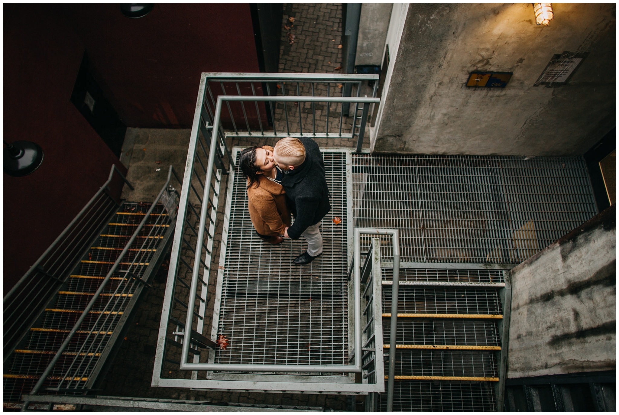granville island engagement couple on metal stairs