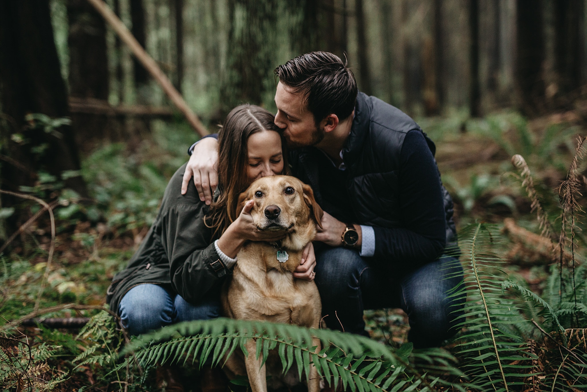 couple kissing dog engagement photos pacific spirit park forest trees