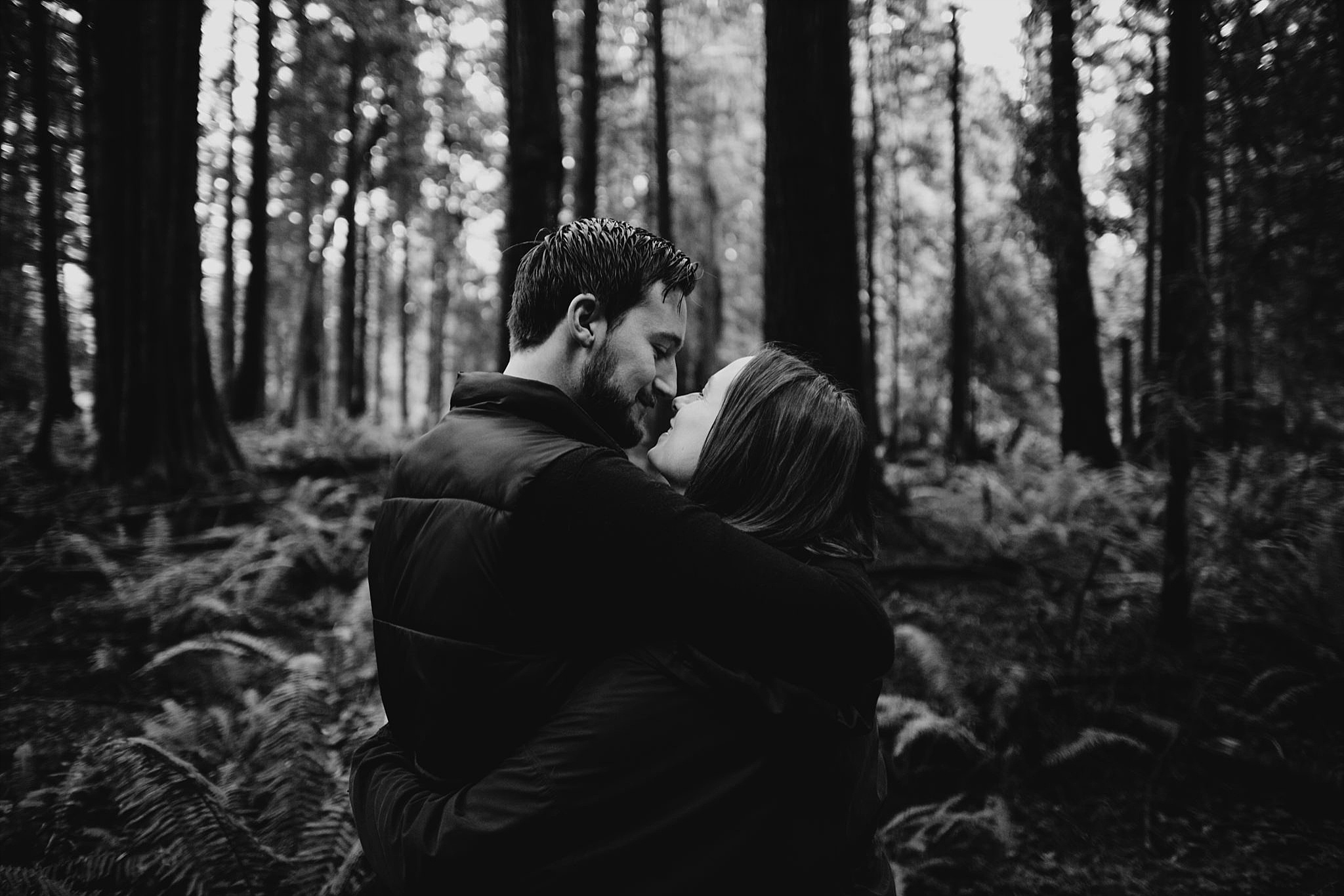 couple intimate engagement photos pacific spirit park tall trees forest