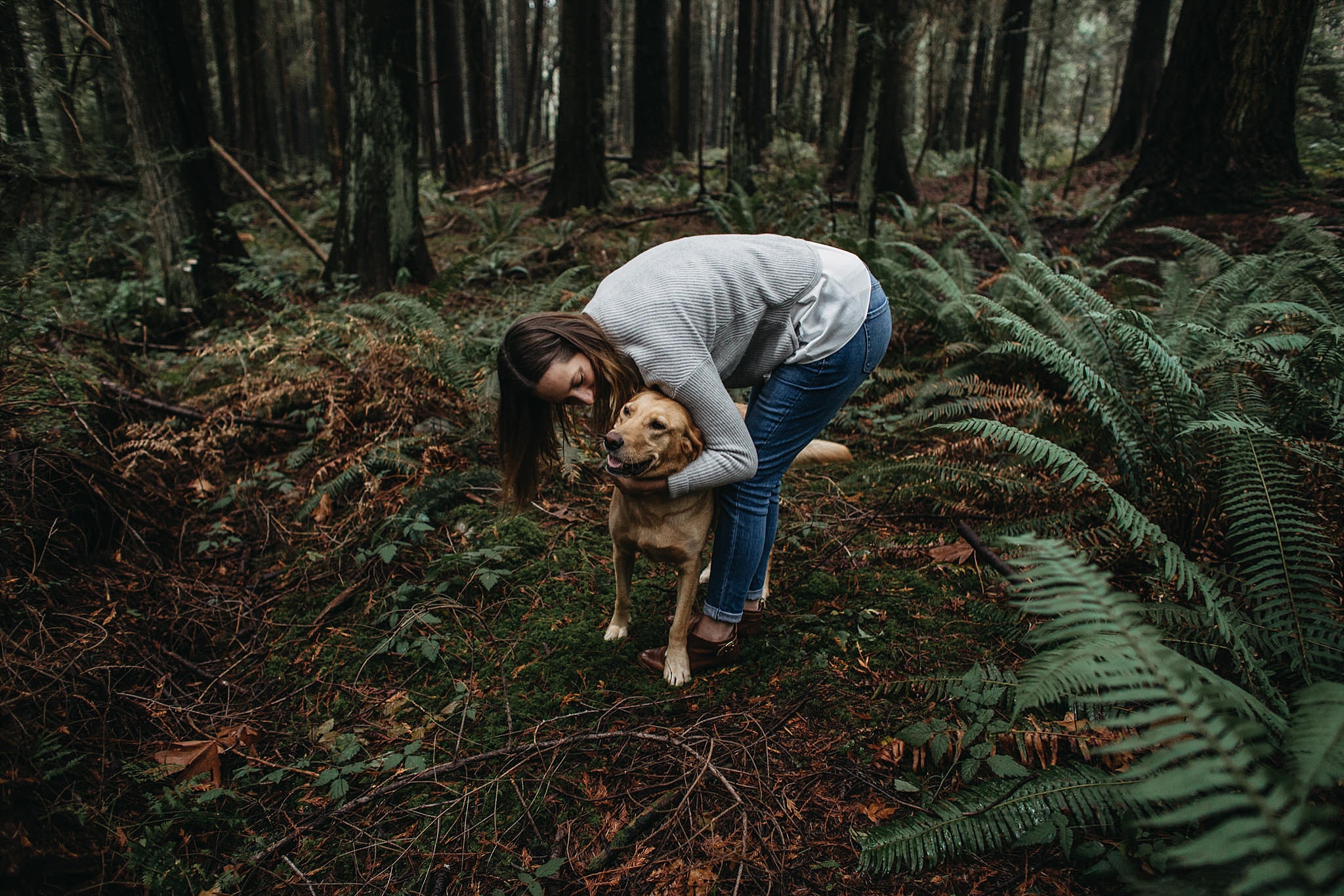 girl kissing dog engagement photos pacific spirit park forest