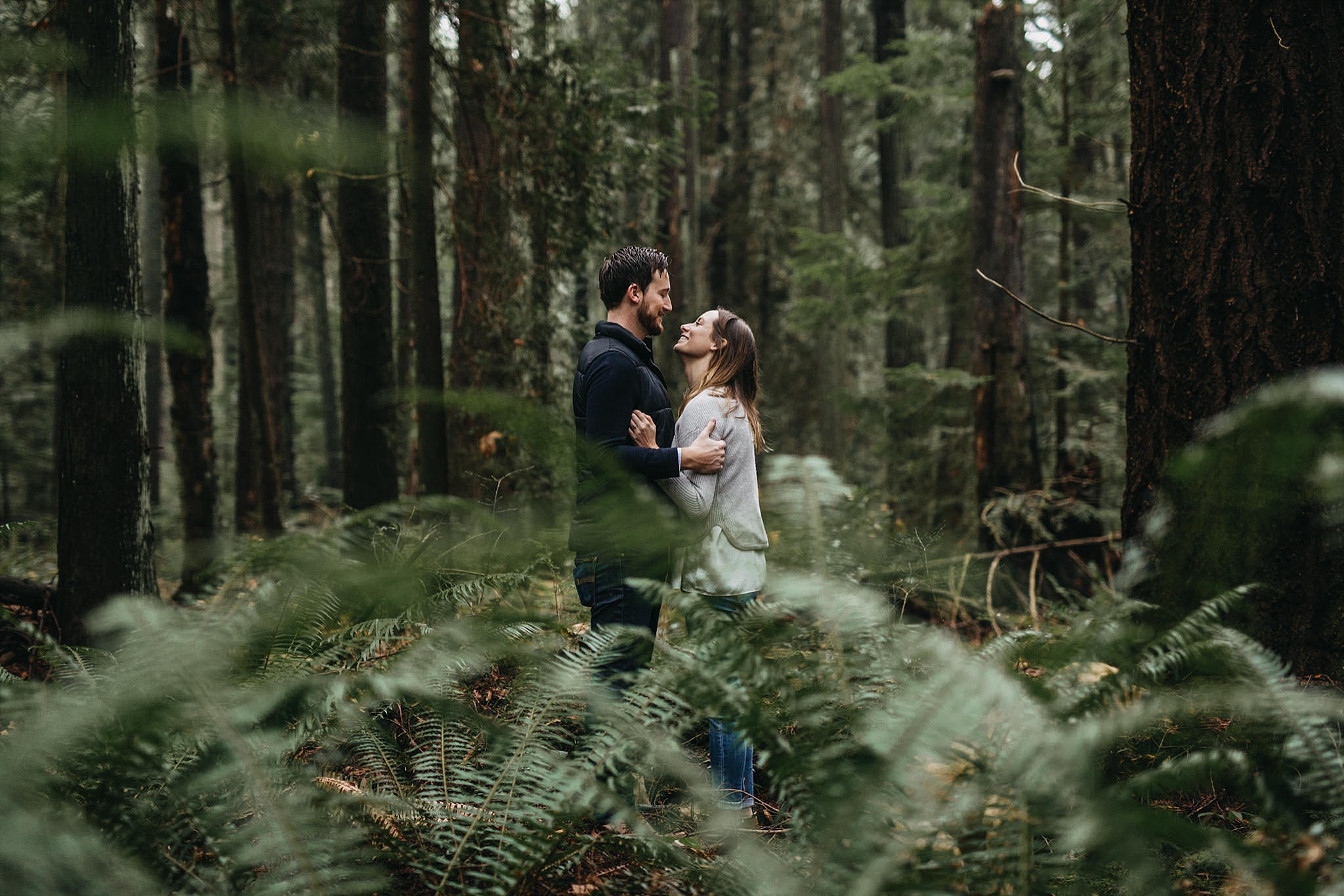 couple in ferns forest pacific spirit park engagement