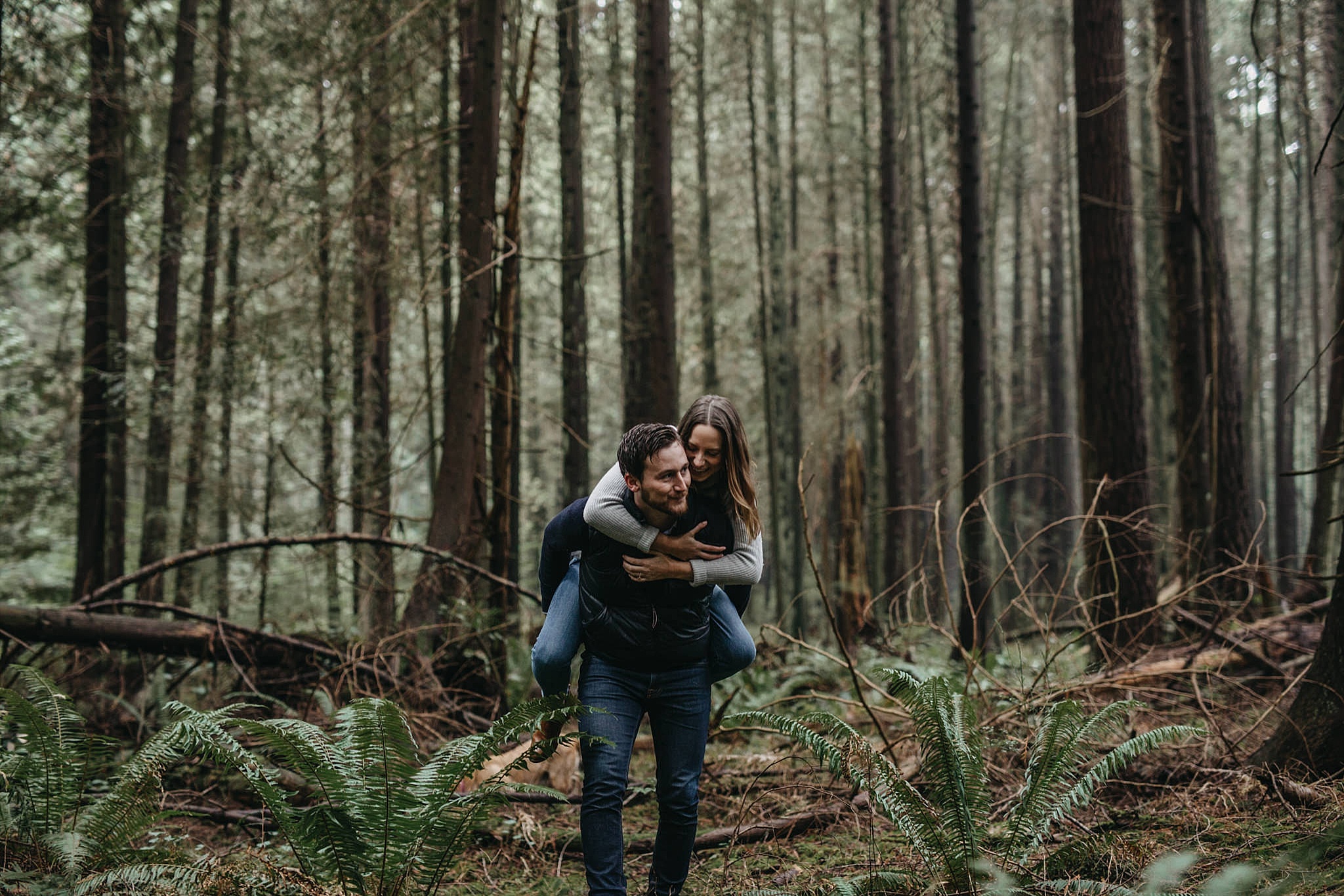 couple piggyback candid moment engagement pacific spirit park